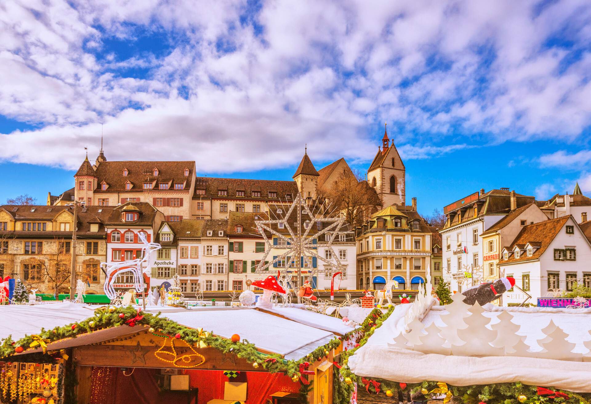 The landmark Barfüsserplatz and Christmas stalls in Basel (Switzerland) on a beautiful winter day.