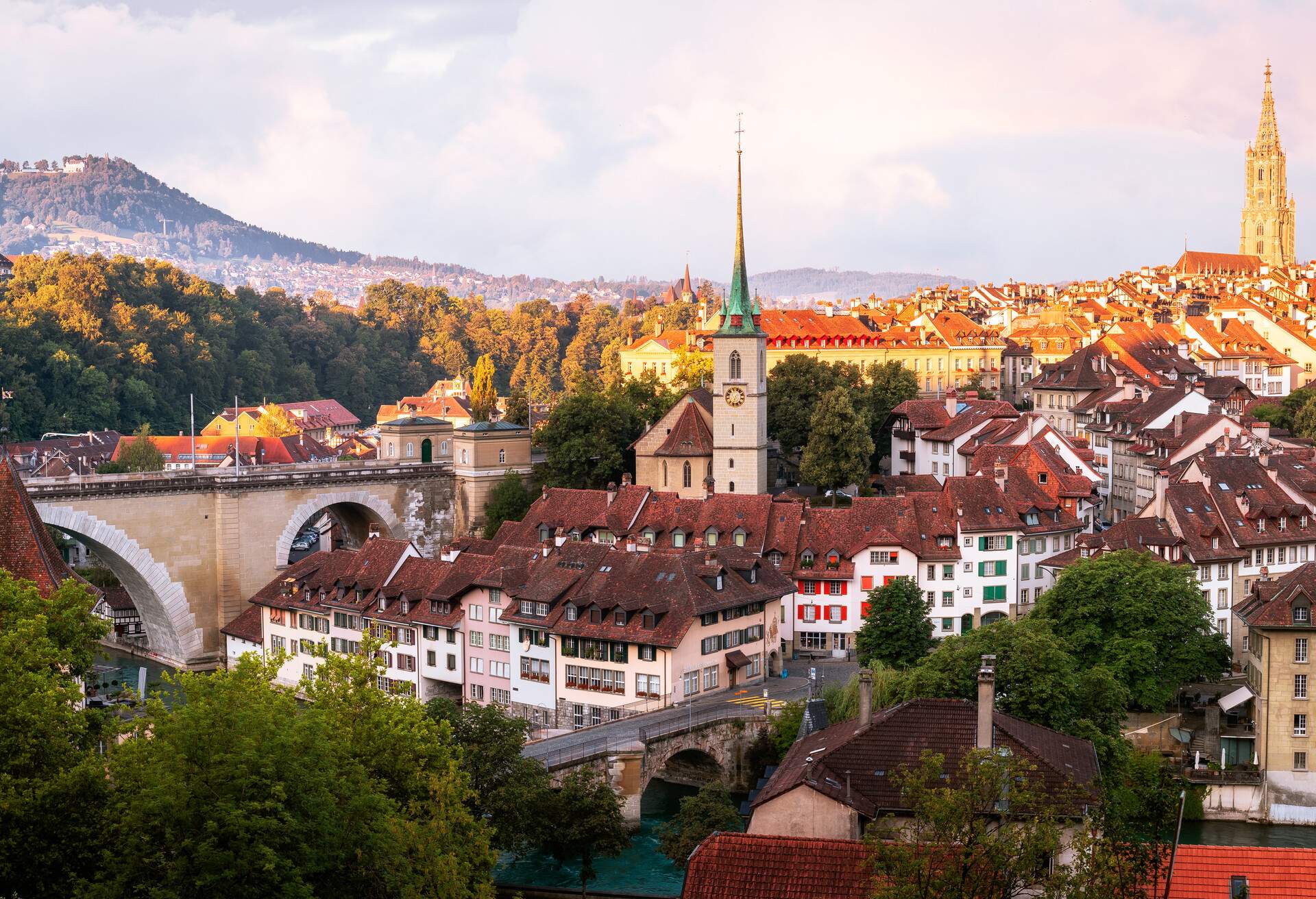 Bern Skyline taken from the Rosengarten at sunrise in Switzerland. ..Church centre: Nydeggkirche.Cathedral right: Berner Münster.Bridge left: Nydeggbrücke