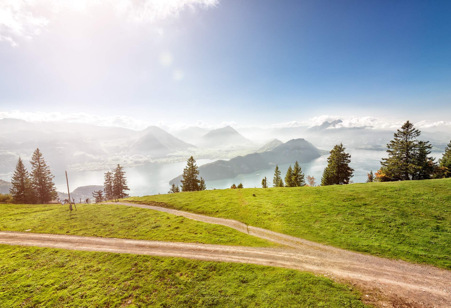 Hiking and mountain bike bicycle trail over lake Lucerne on Mountain Rigi with spectacular view to Bürgenstock and the Swiss alps