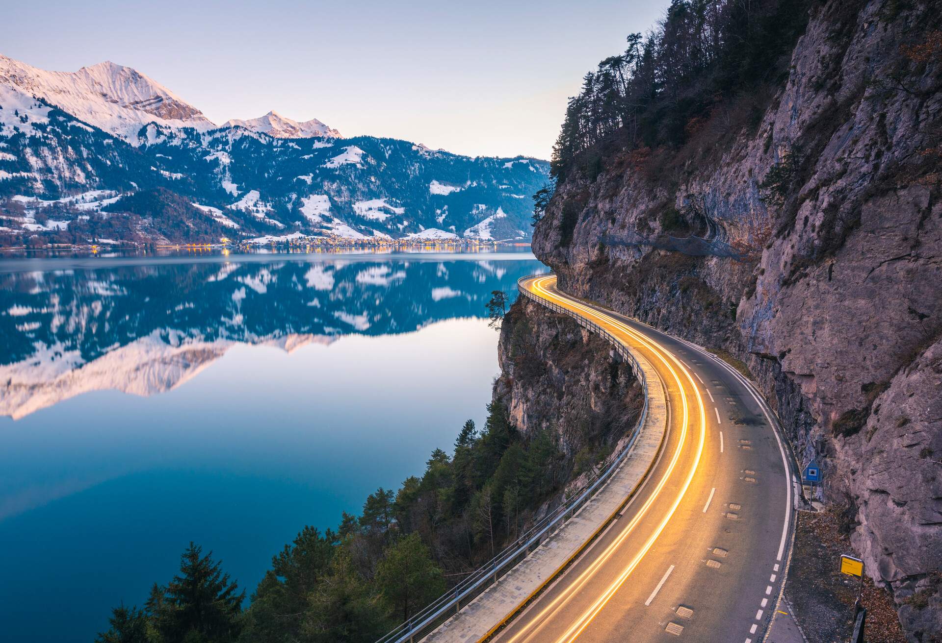 Light trails at dusk on the coastal road along the lake Thun, Berner Oberland, Switzerland