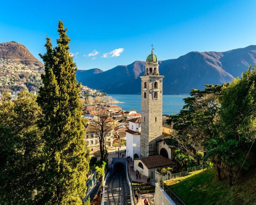 View over the city of Lugano in Switzerland on a sunny winter day. The style of a lot of buildings and churches in Lugano has italian influence due the proximity of the italian border.