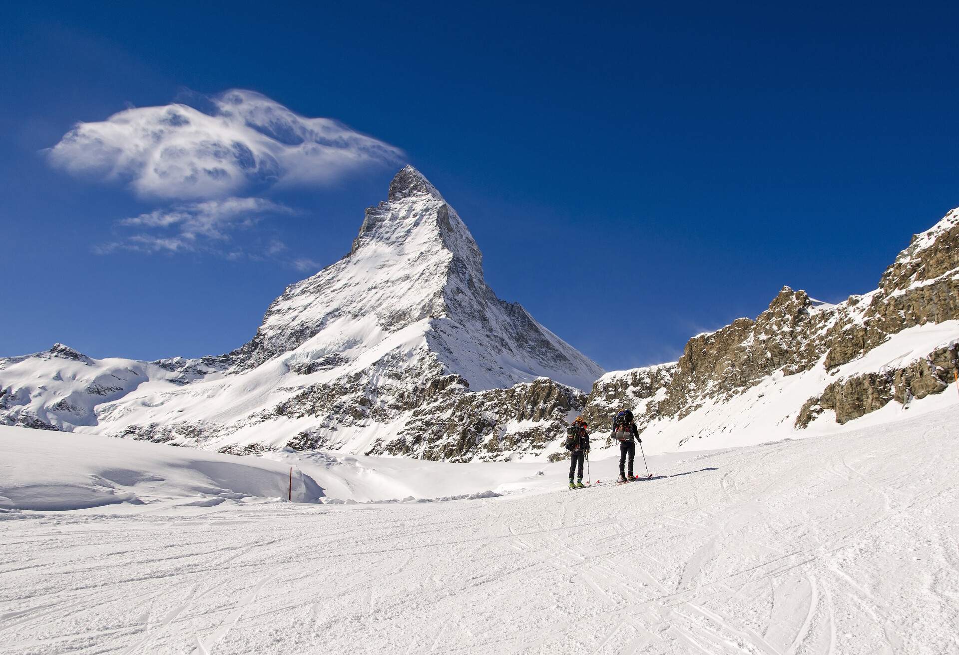 Alpine Touring Skiers ,Swiss Alps. In background the peak of Matterhorn. Swiss-Italy border