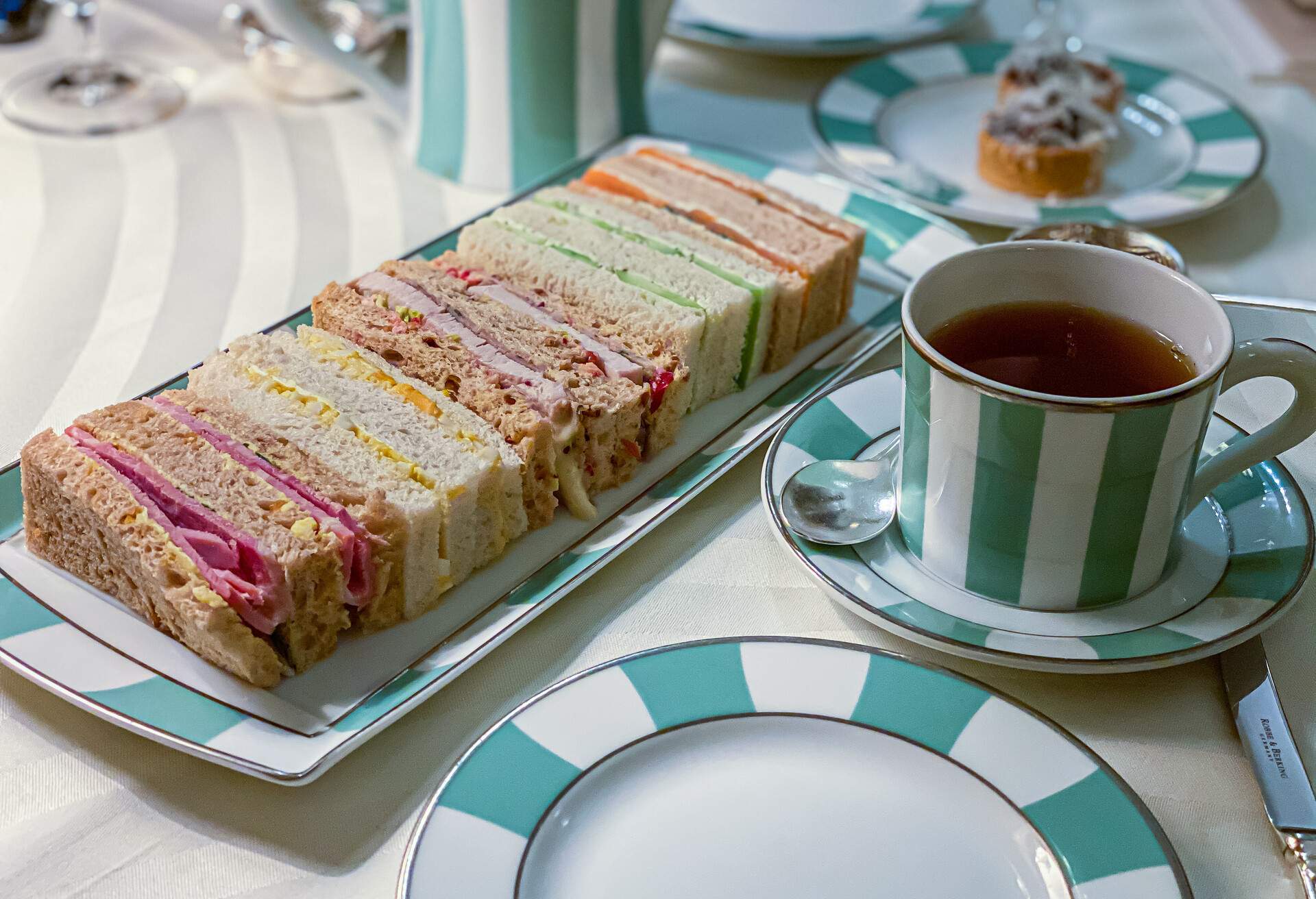 A sandwich platter paired with a cup of tea.