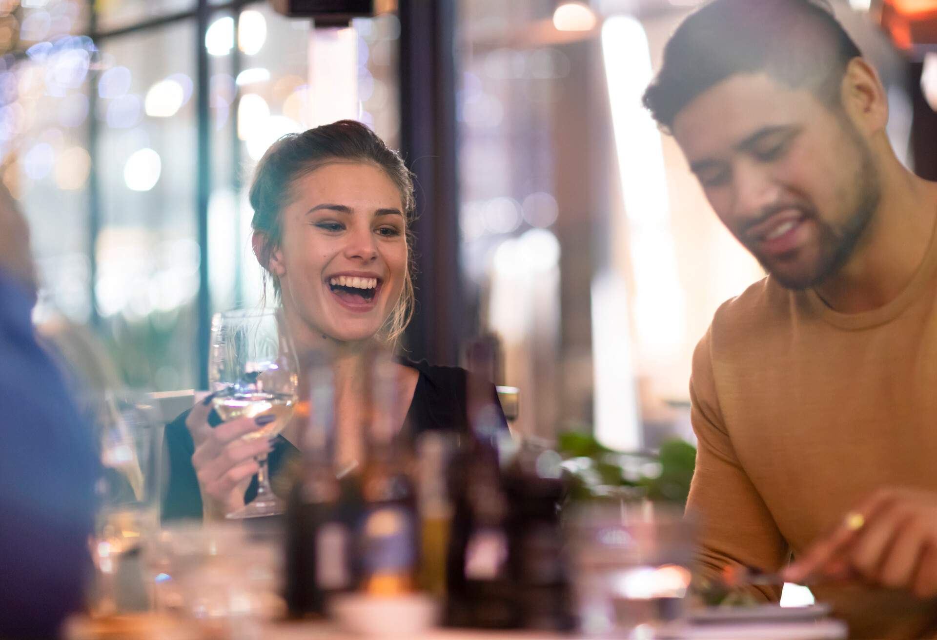 A group of friends share a joke and a laugh over a sophisticated meal at an Auckland restaurant 