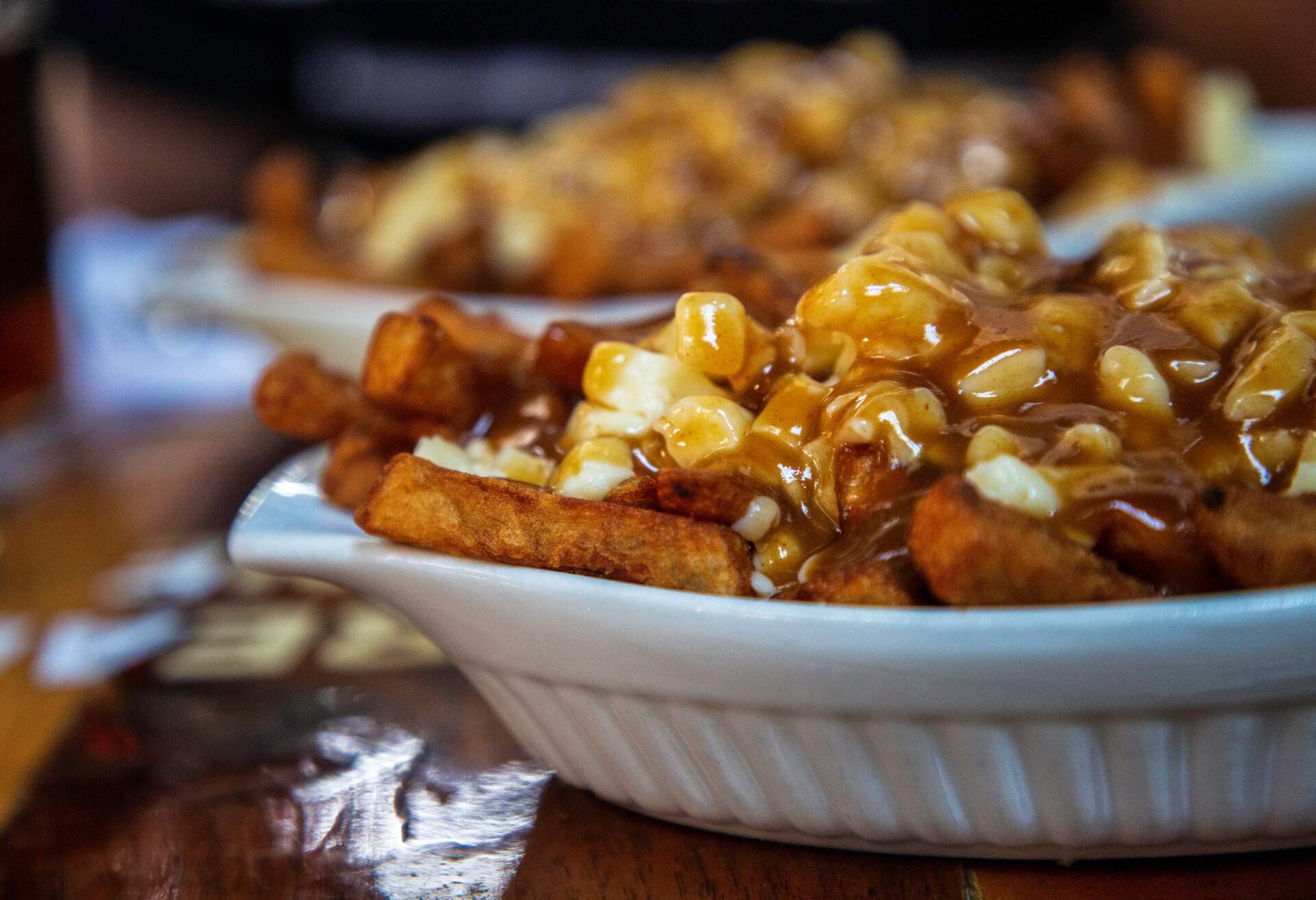Tasty food image, close up image of 2 dishes of poutine