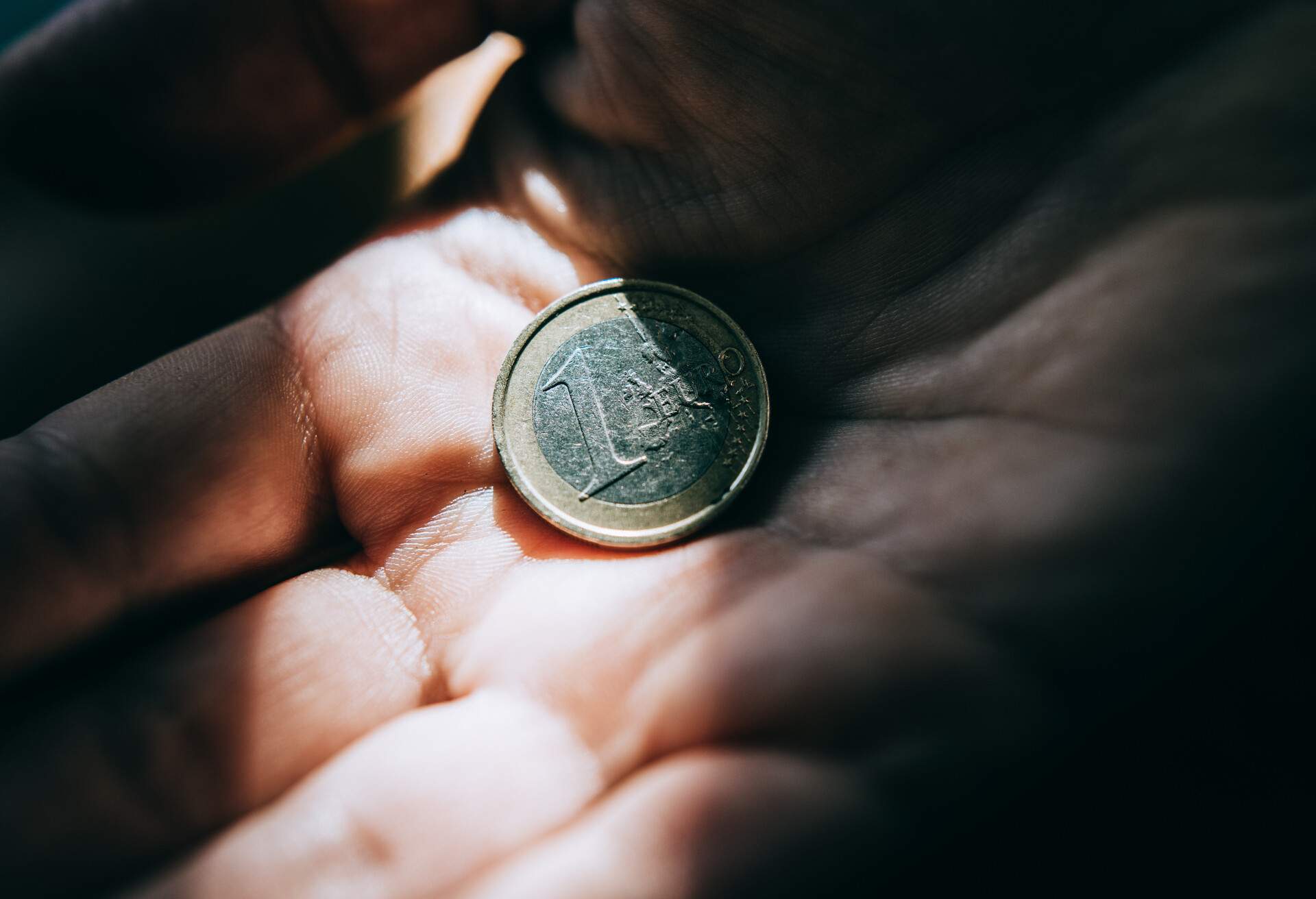 THEME_MONEY_EURO_COIN_HAND_GettyImages-1310163542