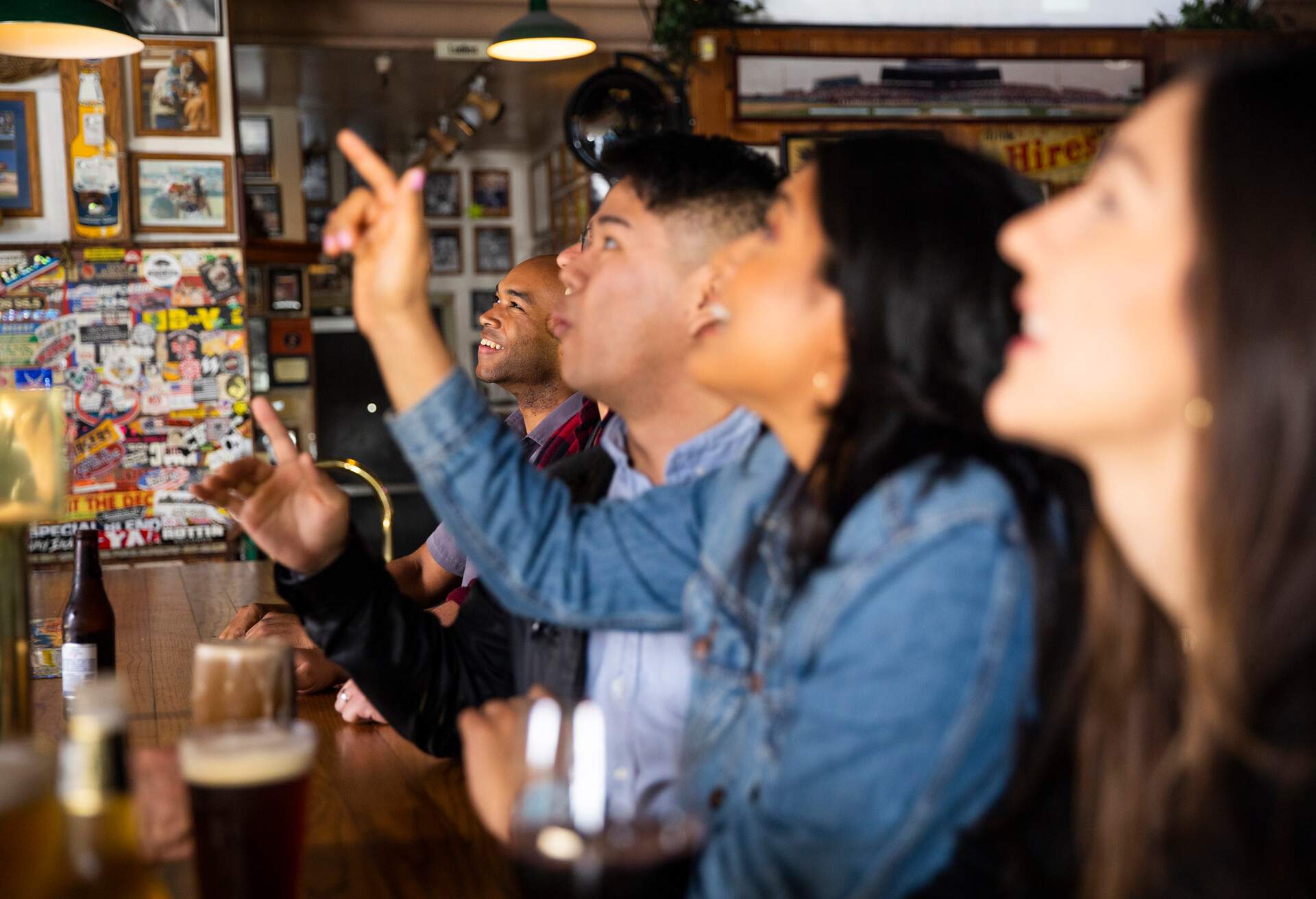 A diverse group of friends having fun at the sports bar 