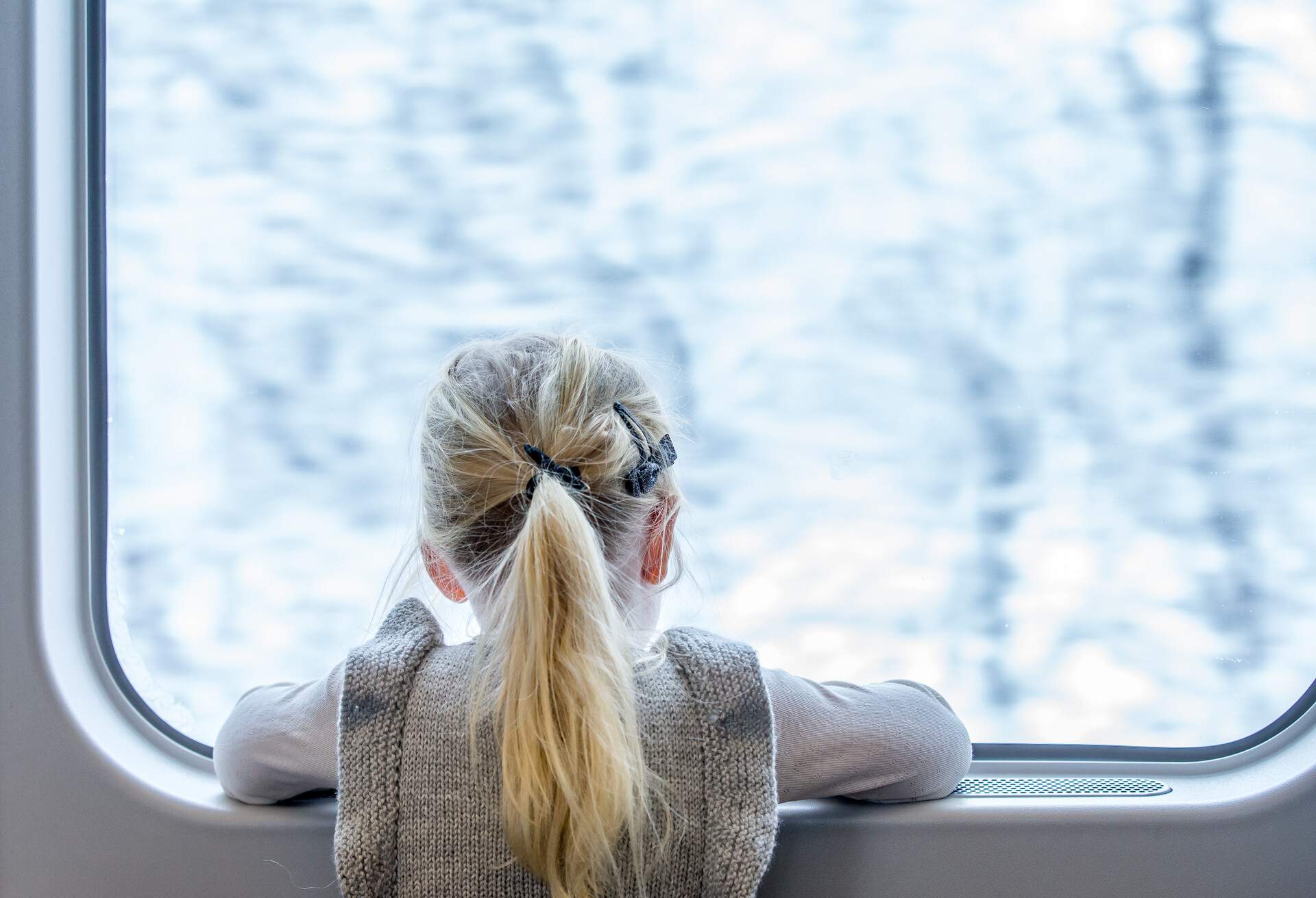Girl riding a train and looking out of the window, NORWAY