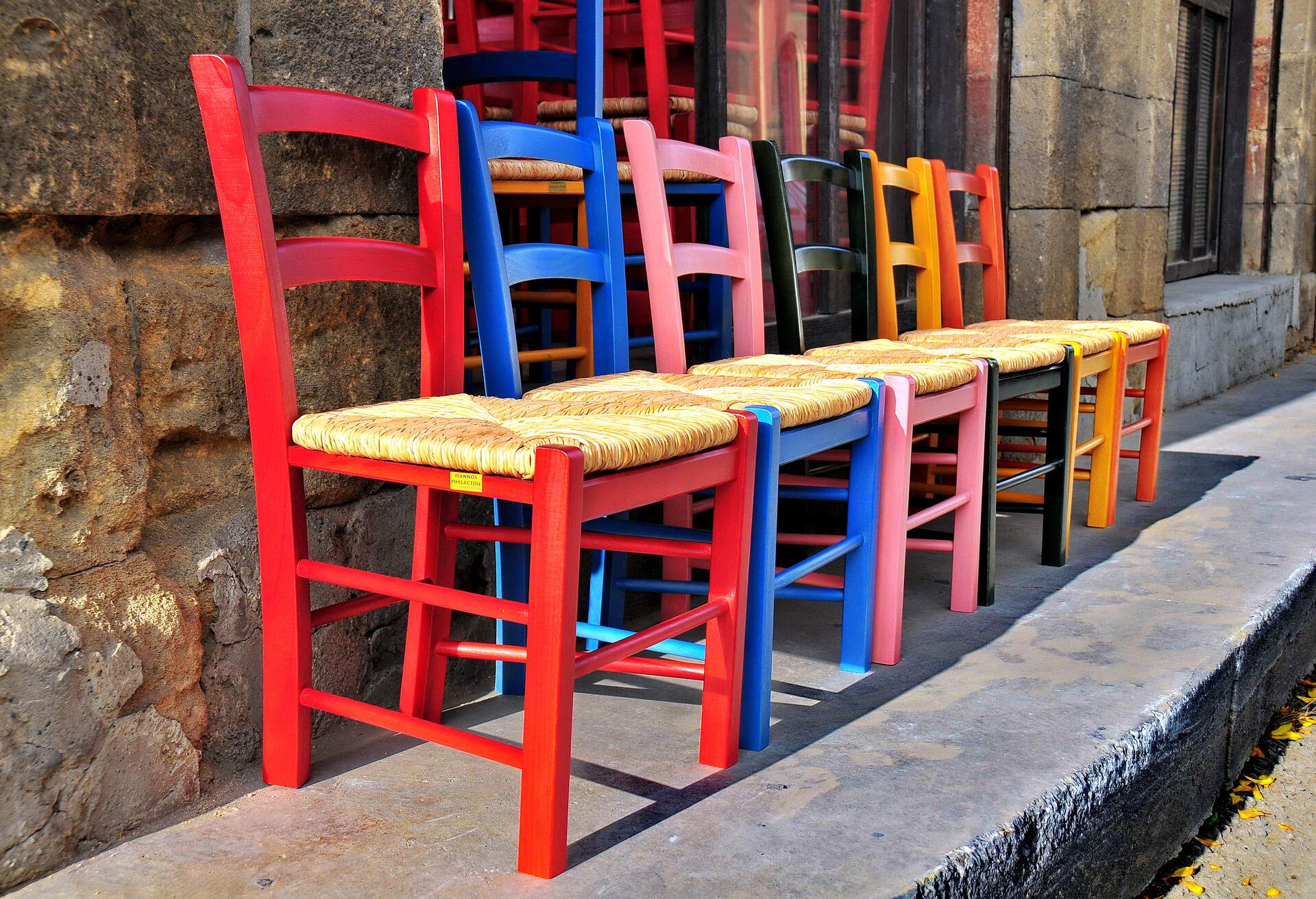 Colourful children's chairs as exhibited outside a traditional Cypriot chair maker's workshop at Old Strovolos, Nicosia.