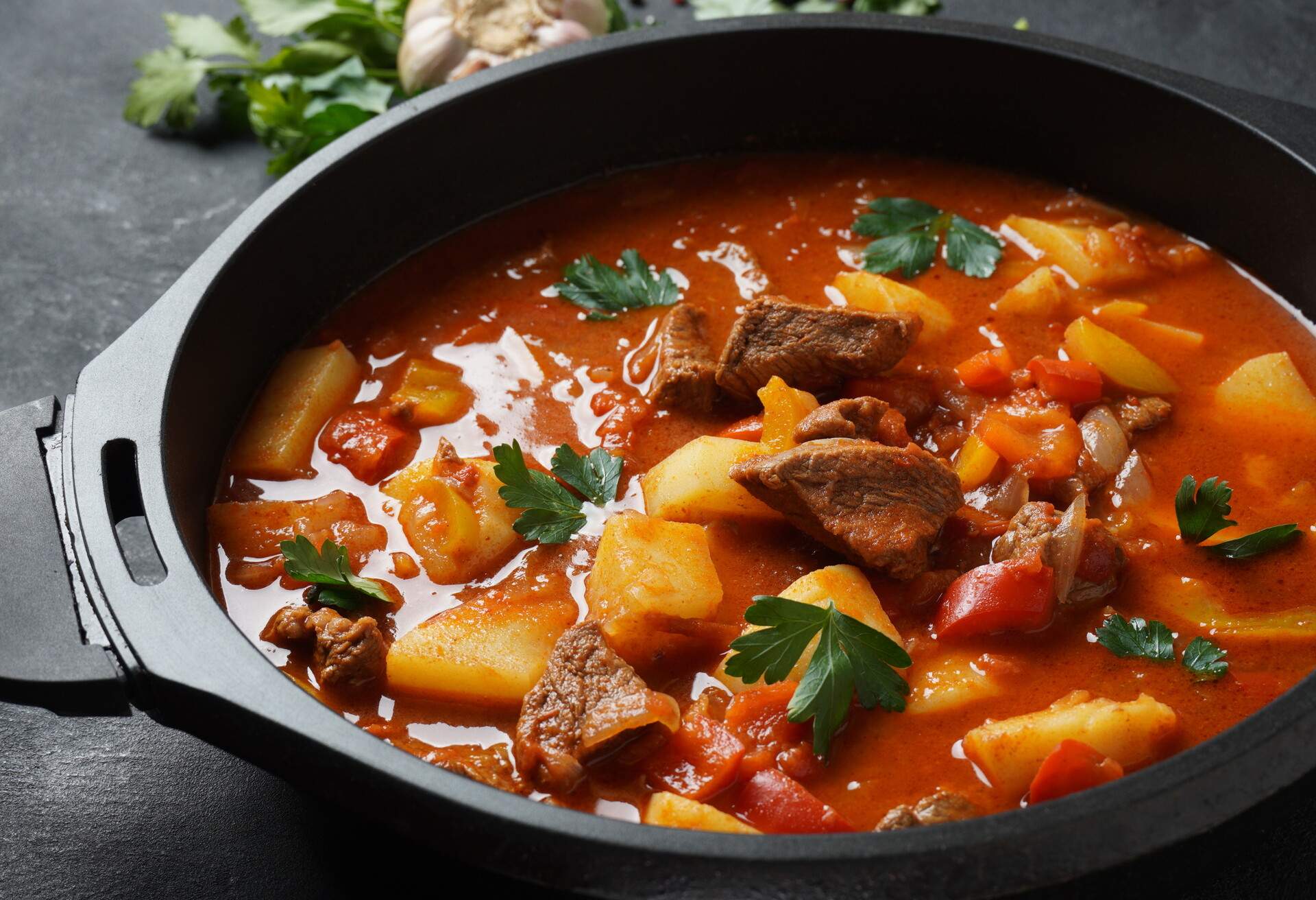 Beef goulash, soup and a stew, made of beef chuck steak, potatoes and plenty of paprika. Hungarian  traditional meal.