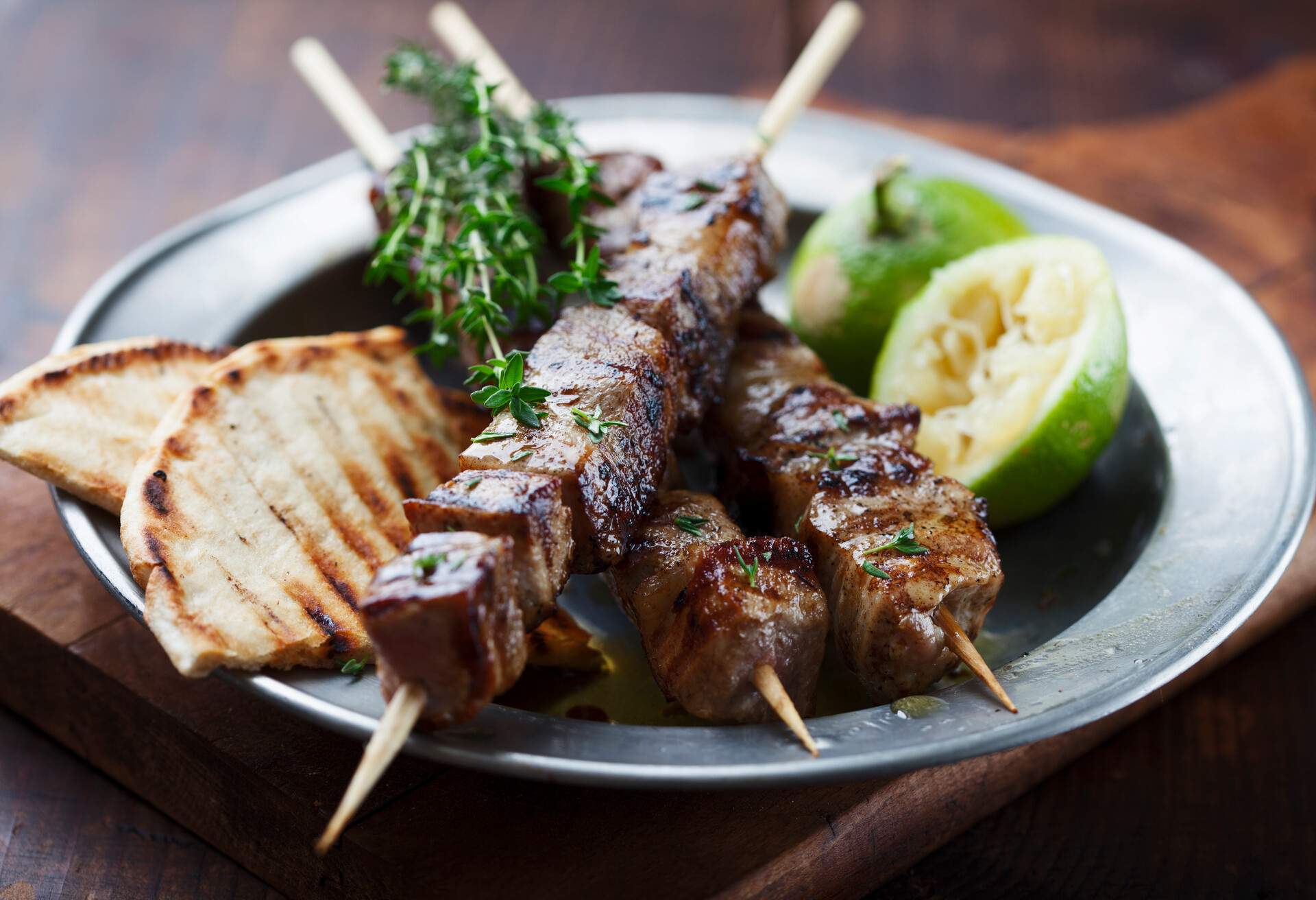 meat skewer with herbs, lime and pita bread
