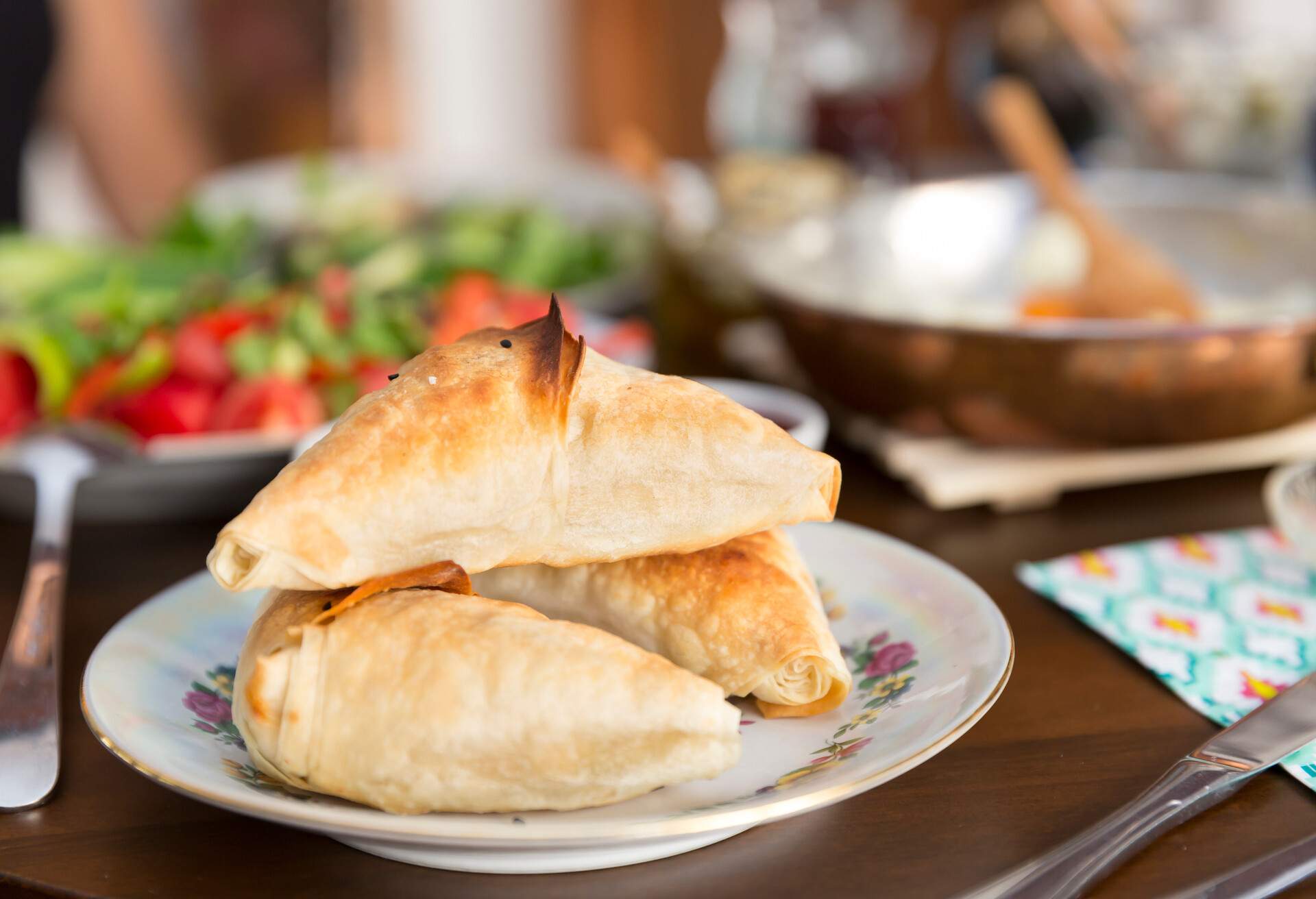 Turkish and Balkans Traditional Puff pastry with meat or cheese. Samosa or Muska Boregi  is a family of baked filled pastries made of a thin flaky dough known as phyllo or yufka of Anatolian origins.; Shutterstock ID 1019375011; Purpose: ; Brand (KAYAK, Momondo, Any):