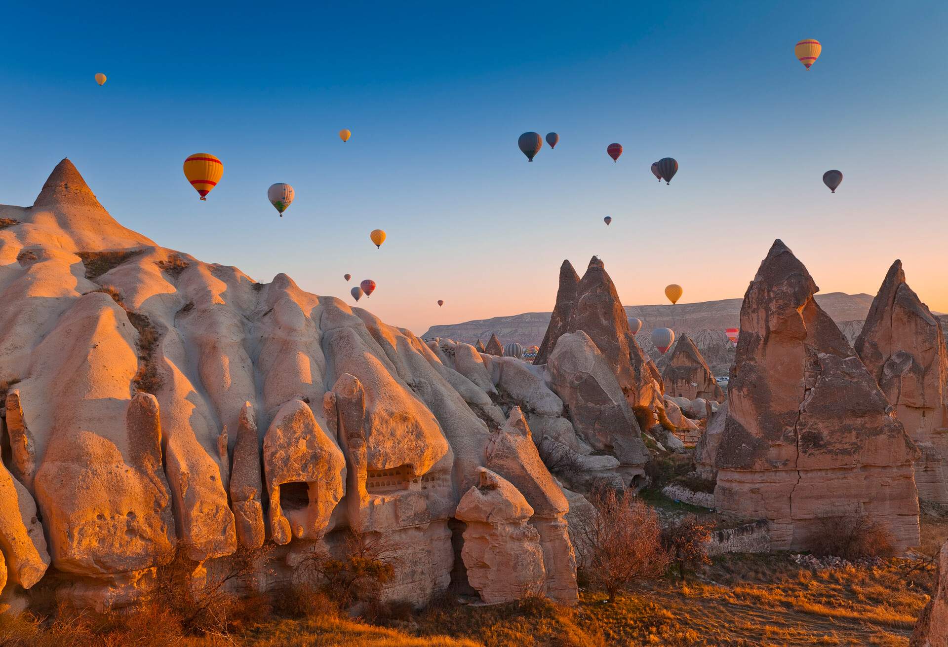 Hot Air Balloons rise up over the Goreme Valley in Cappadocia, Turkey