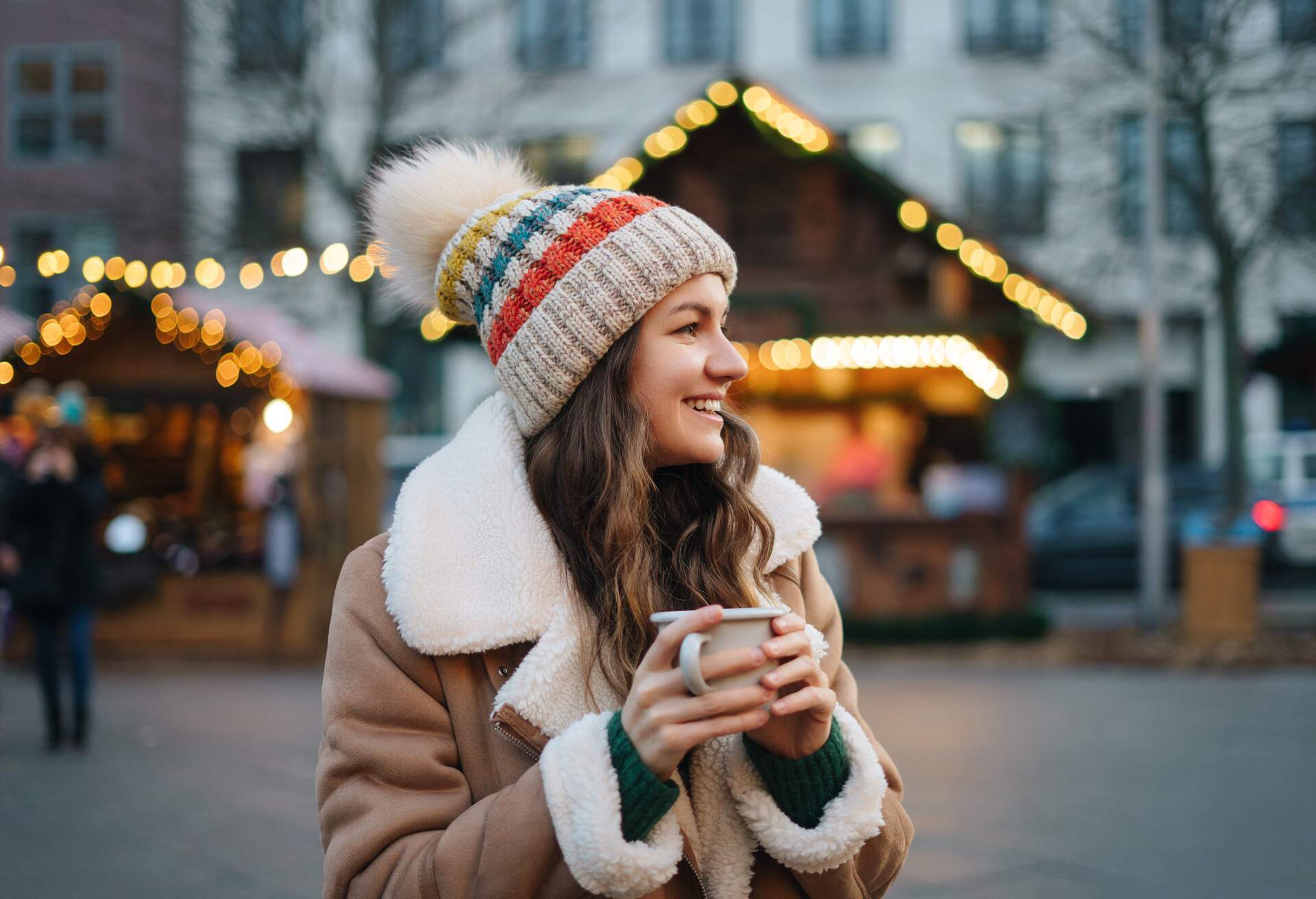 Happy smiling woman having fun at the Christmas market