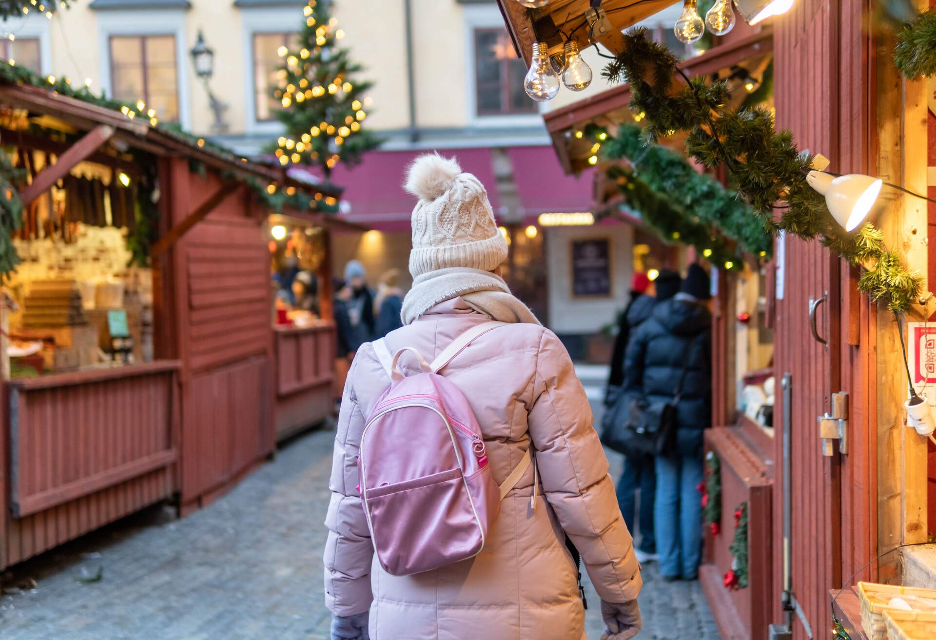 A woman walking through Christmas market in Stockholm