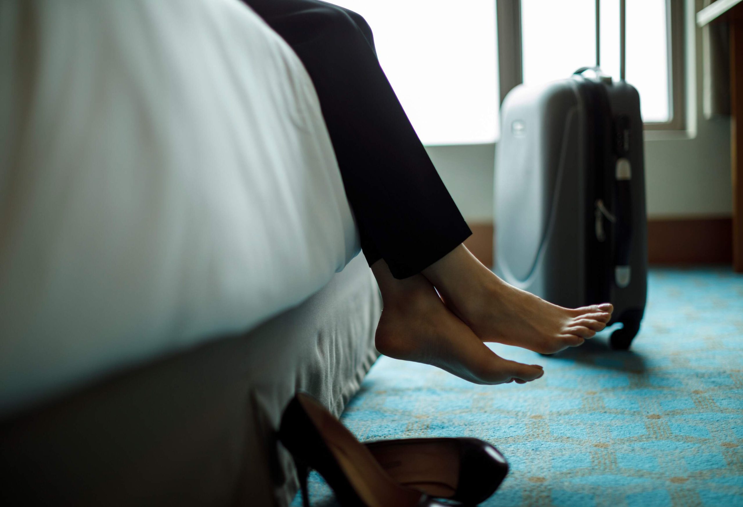 theme_travel_hotel_room_bed_woman_relaxing_gettyimages-945106690