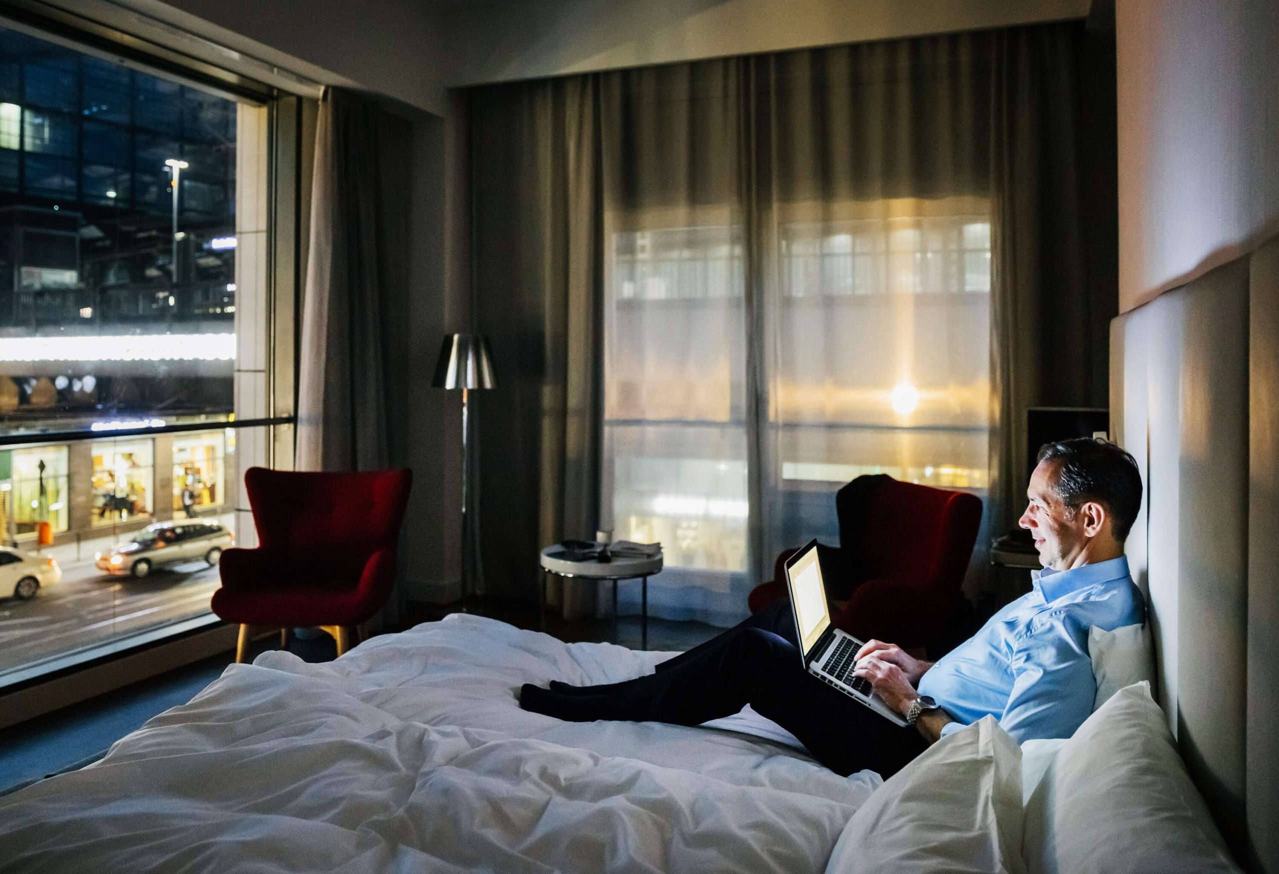 dest_germany_berlin_hotel_room_bed_person_man_male_businessman_laptop_gettyimages-689008376