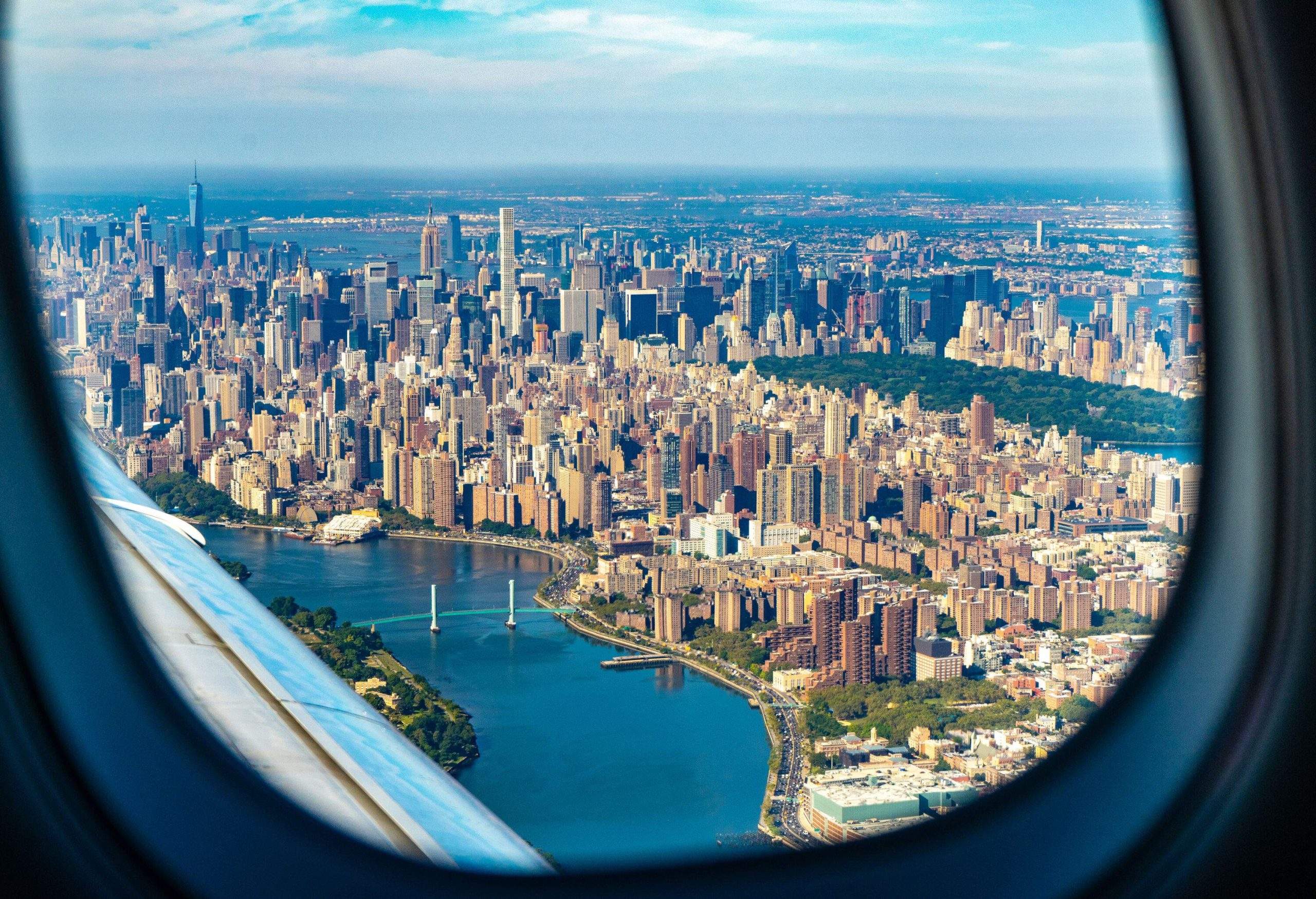 Airplane window view of the urban landscape of a city.