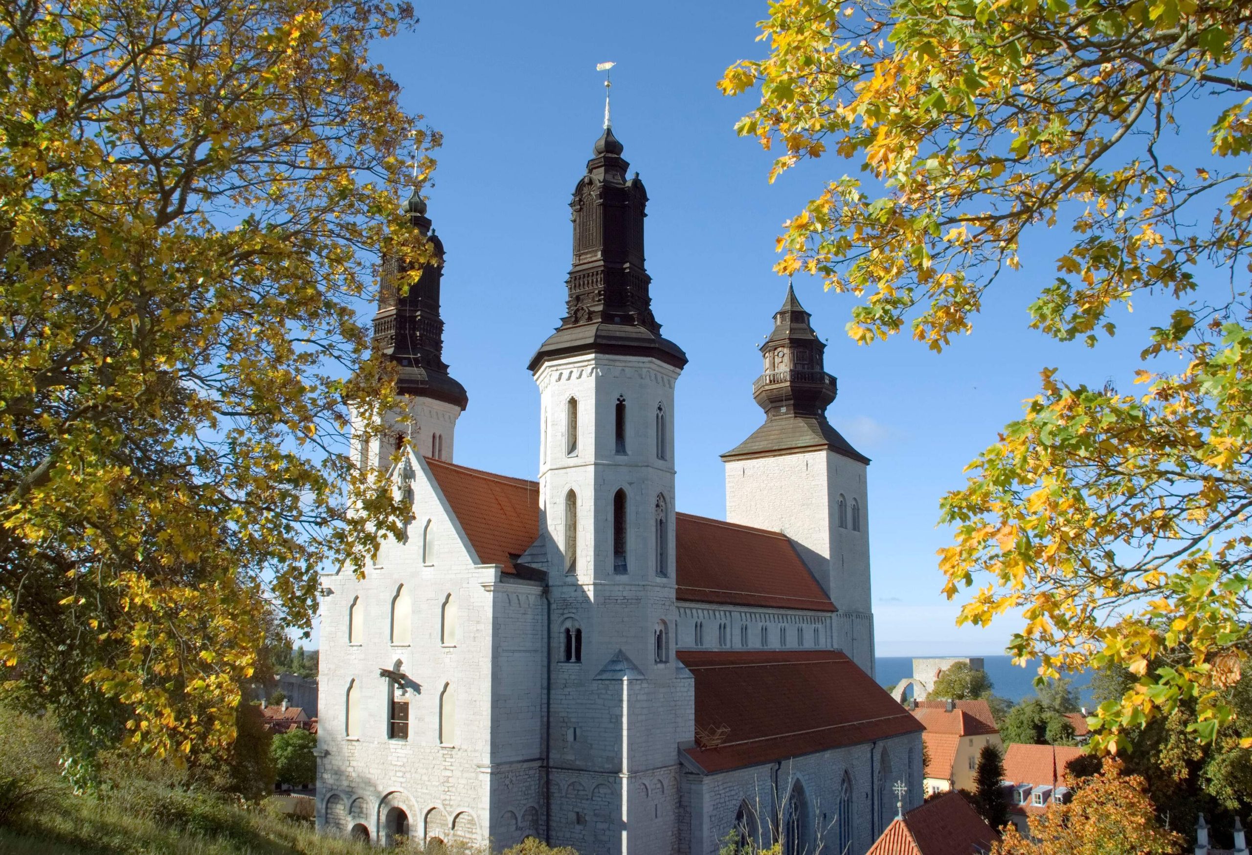 A medieval stone church on a hill with octagonal towers on the roof.