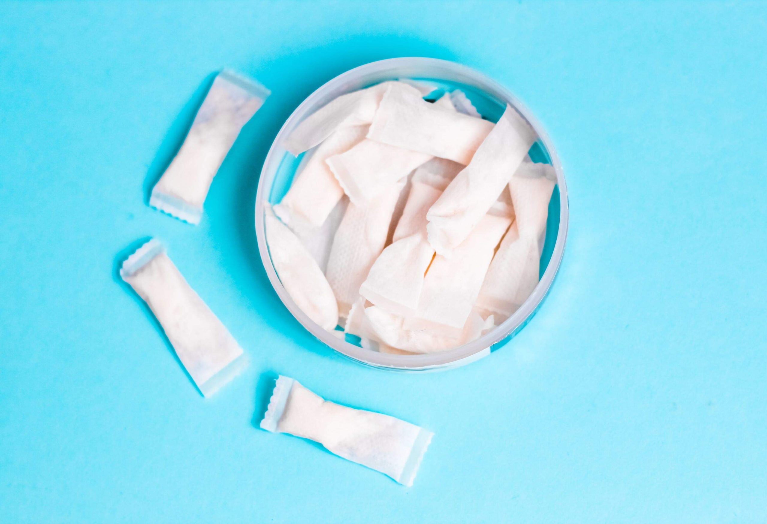 Nicotine pads snus, cigarette replacement, for gum, on a simple blue background