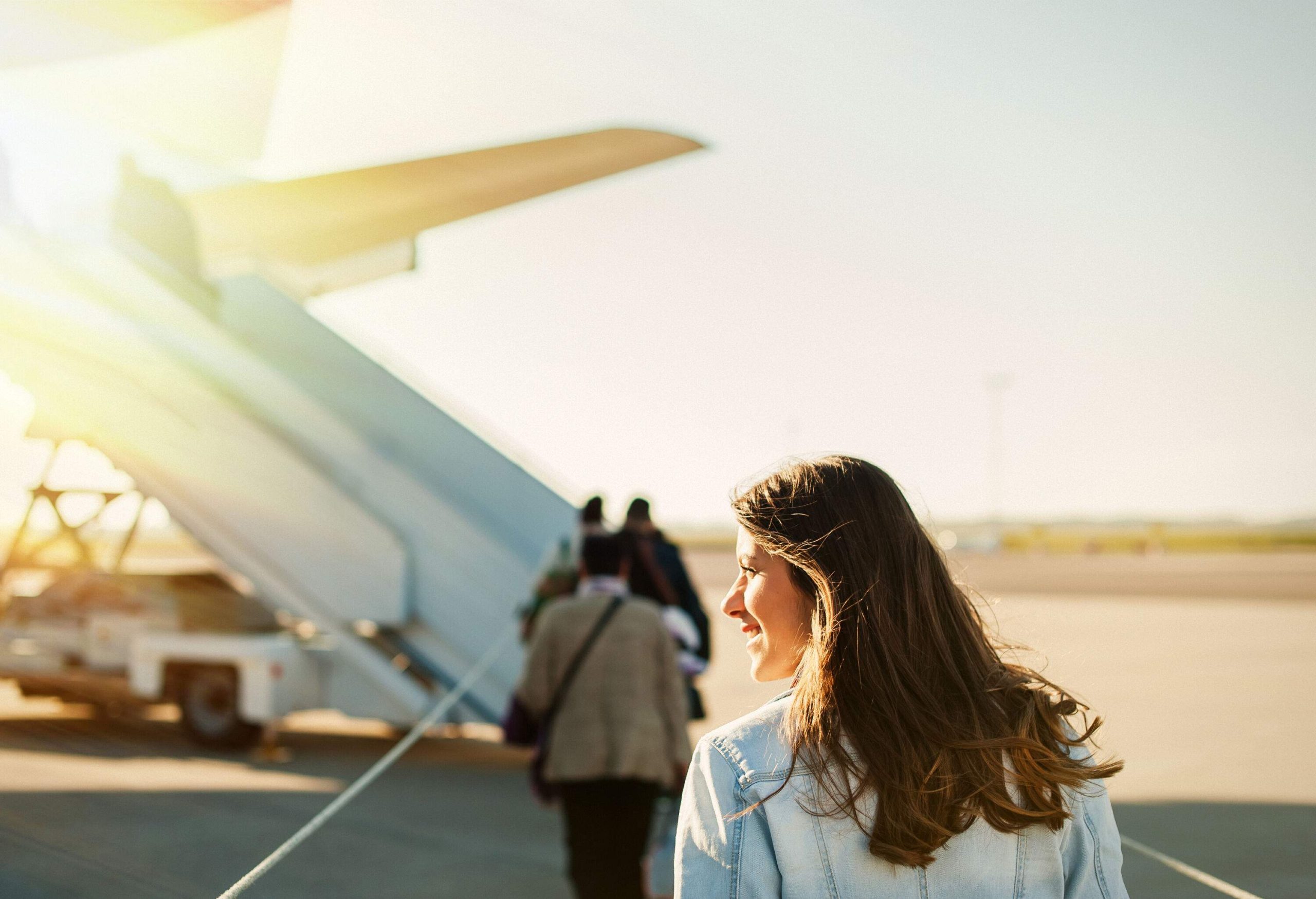 Passengers boarding the plane on the tarmac.