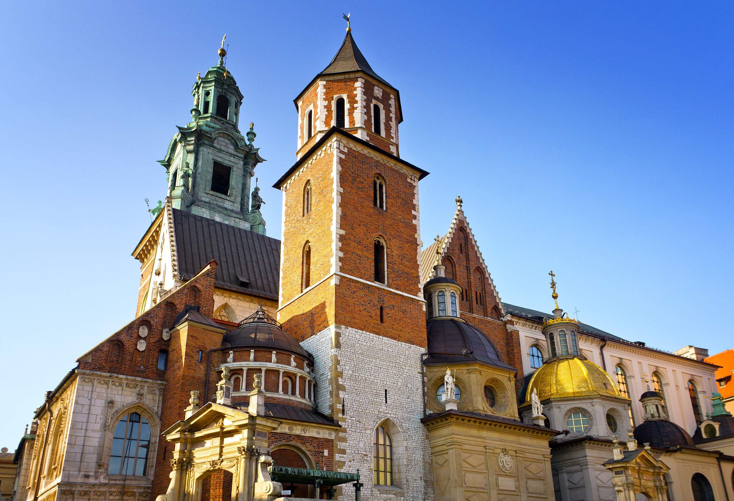 The Wawel Cathedral's eclectic façade with its iconic towers and lantern-topped domes.