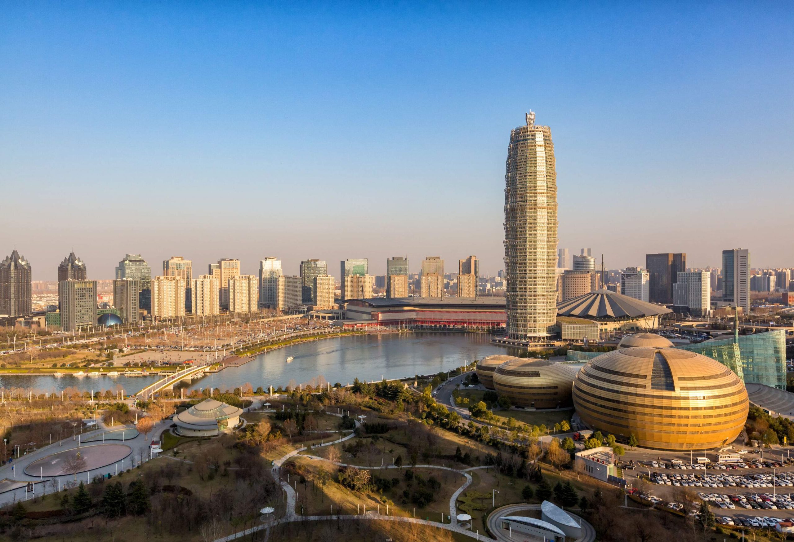 Tall and unique skyscrapers in a metropolitan area surrounding a river.