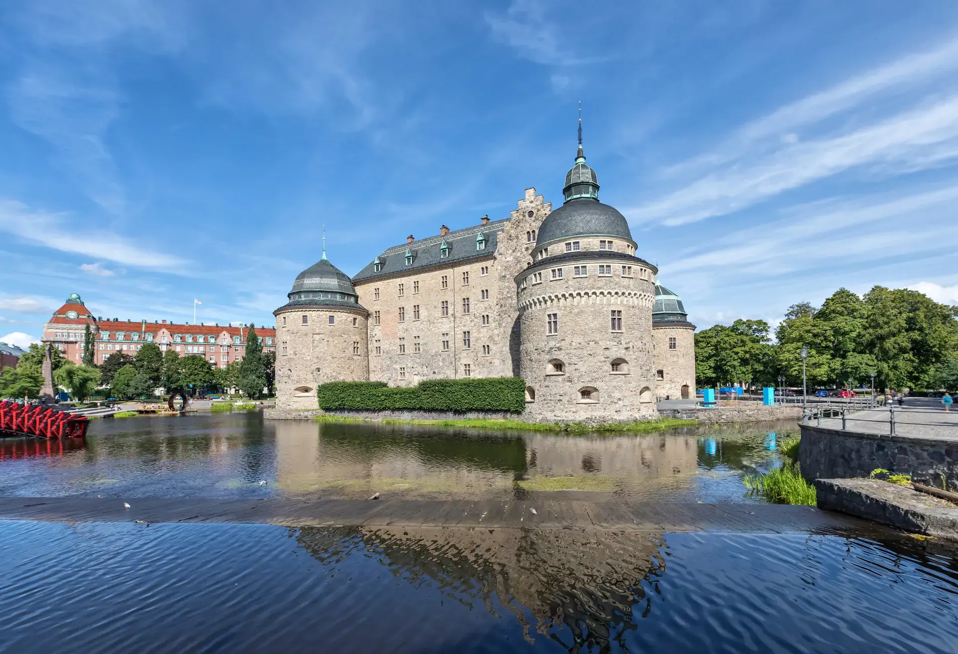 Orebro castle reflecting in water on sunny summer day in city Orebro, Sweden; Shutterstock ID 699779347