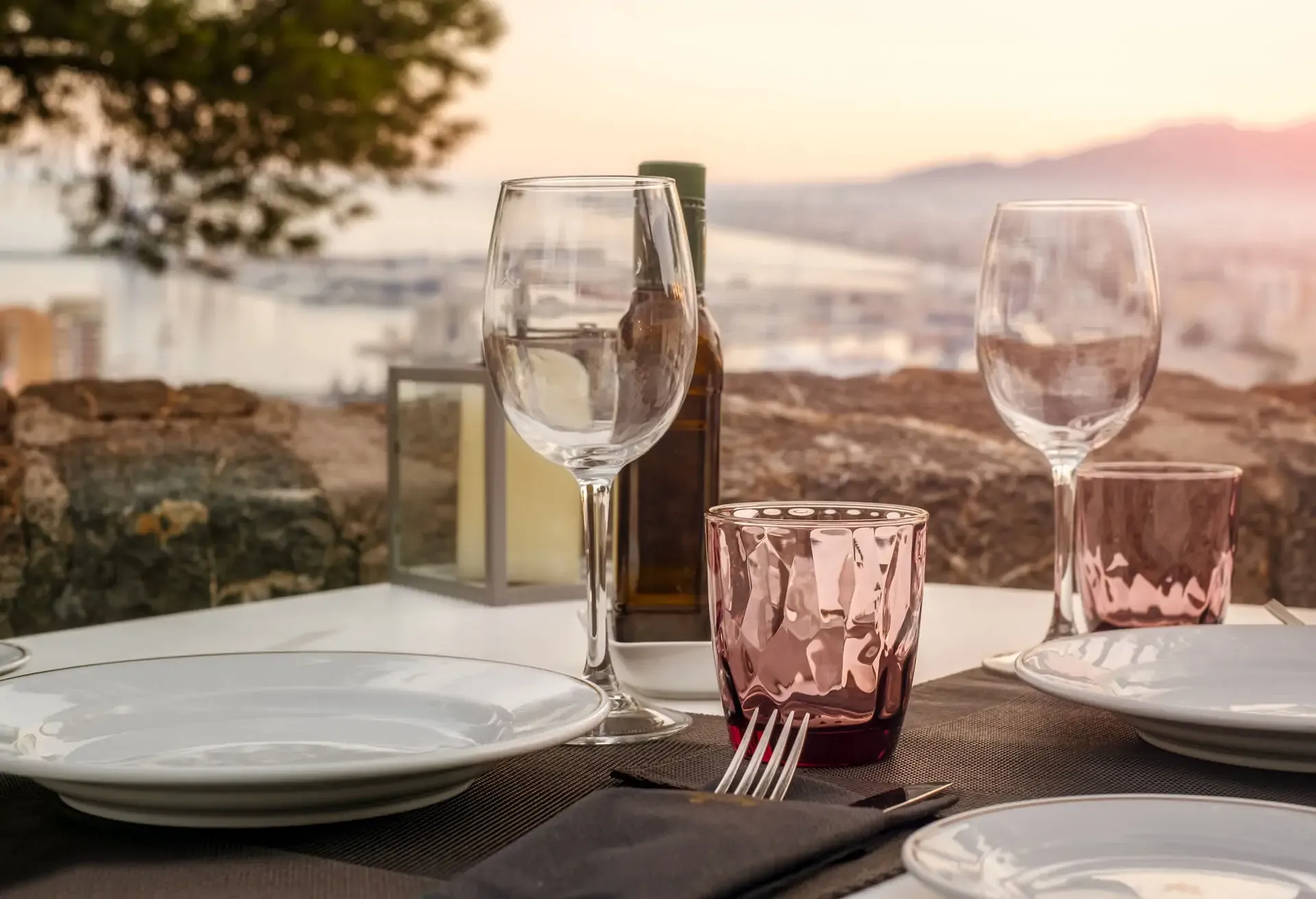 dest_spain_malaga_theme_restaurant_sunset_wine_glass_gettyimages-1420931866_universal_within-usage-period_89729