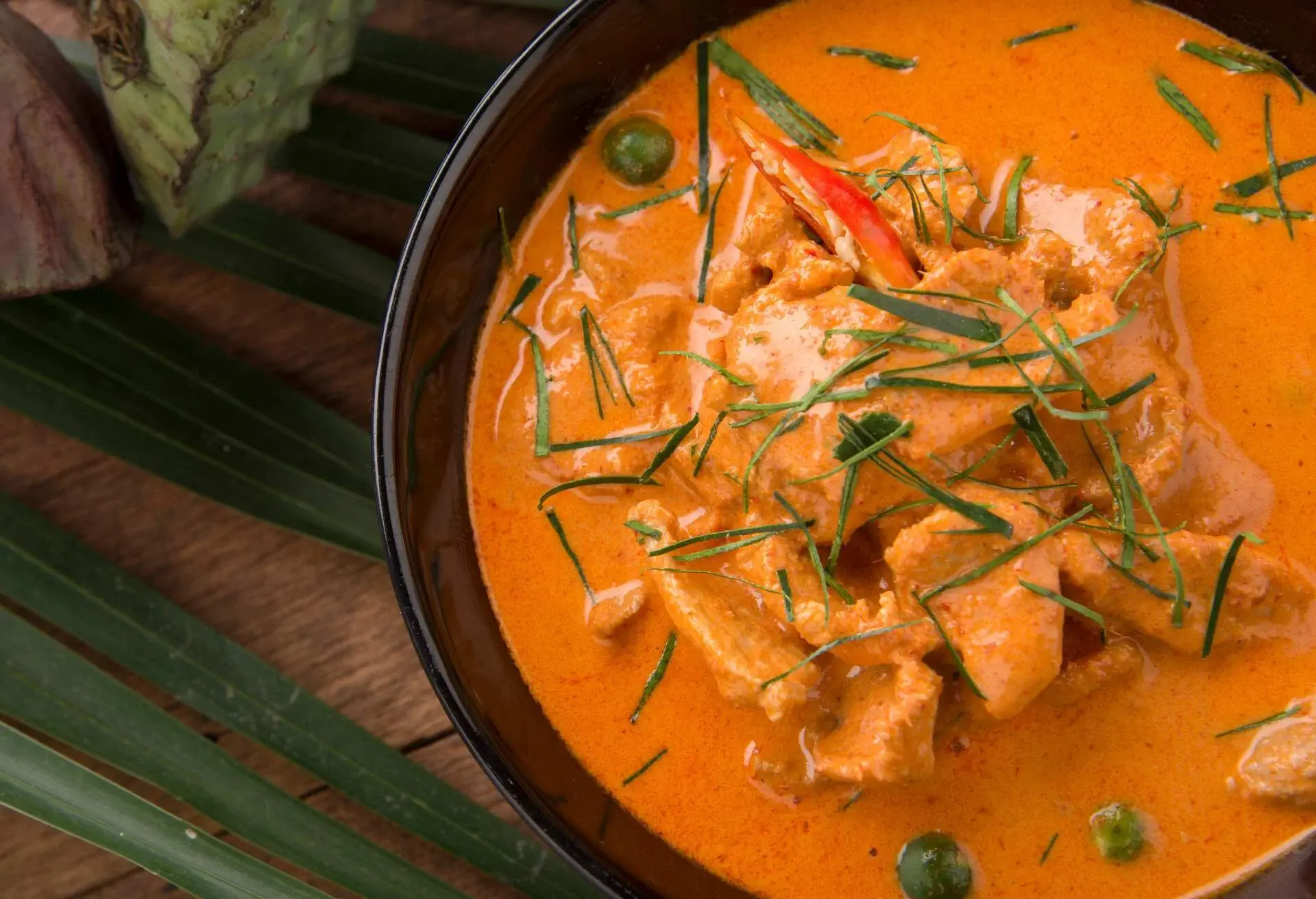 Thai curry red soup,Thailand tradition red curry with beef,pork or chicken menu in thai name is panaeng.Curry menu with coconut milk.Panaeng Curry on Wooden table