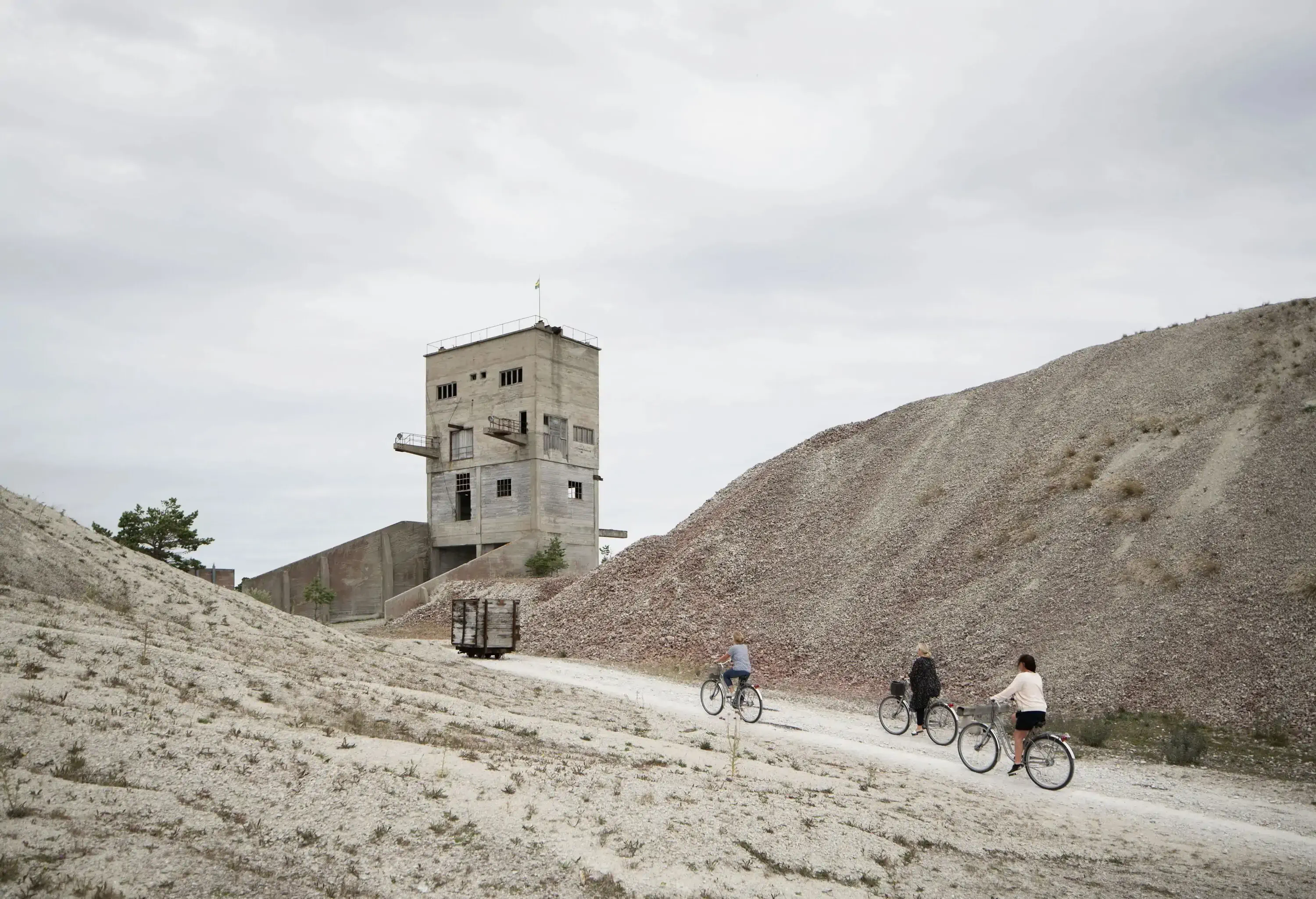 People cycling up an abandoned mine and industrial estate