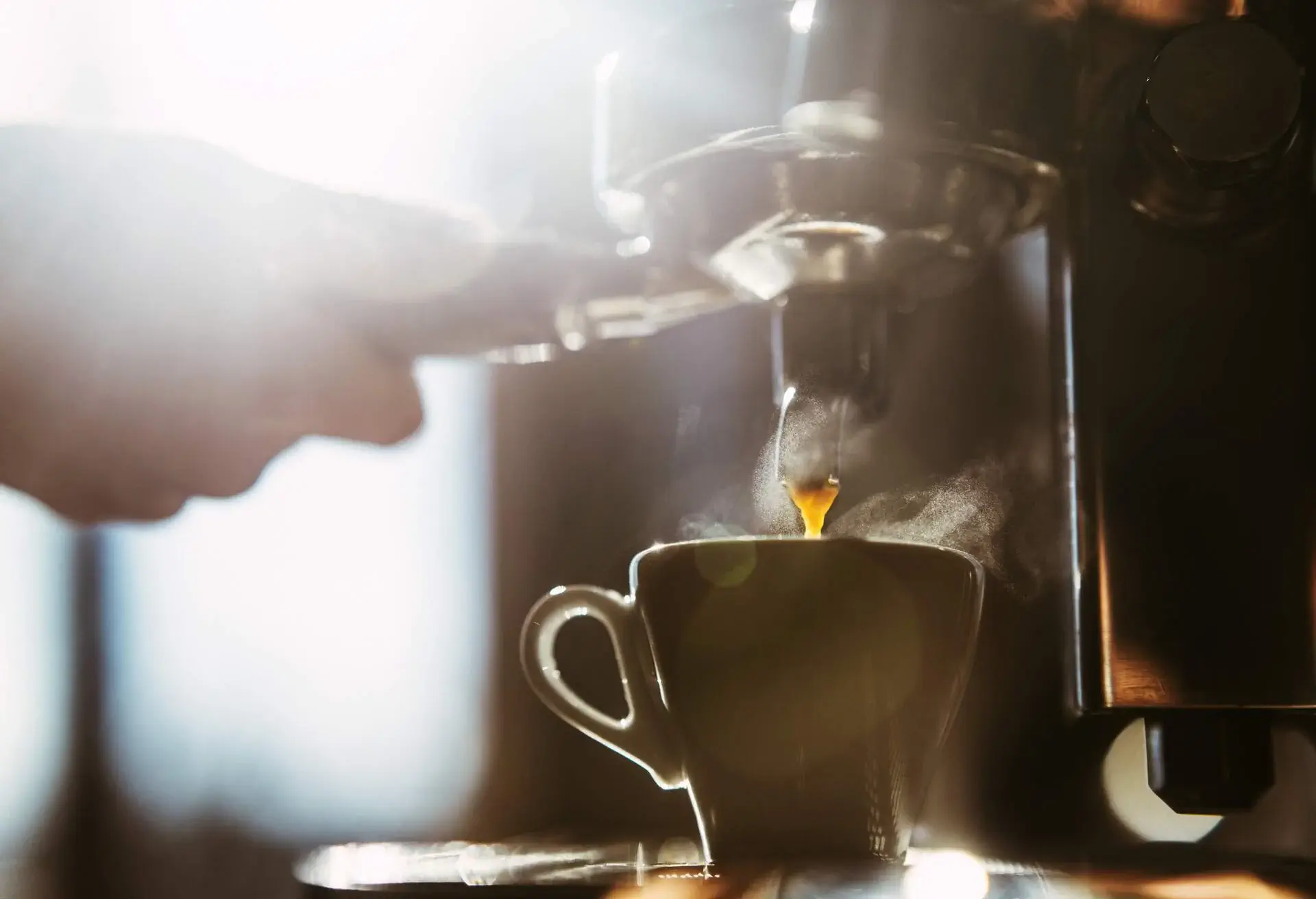 Woman making espresso coffee.