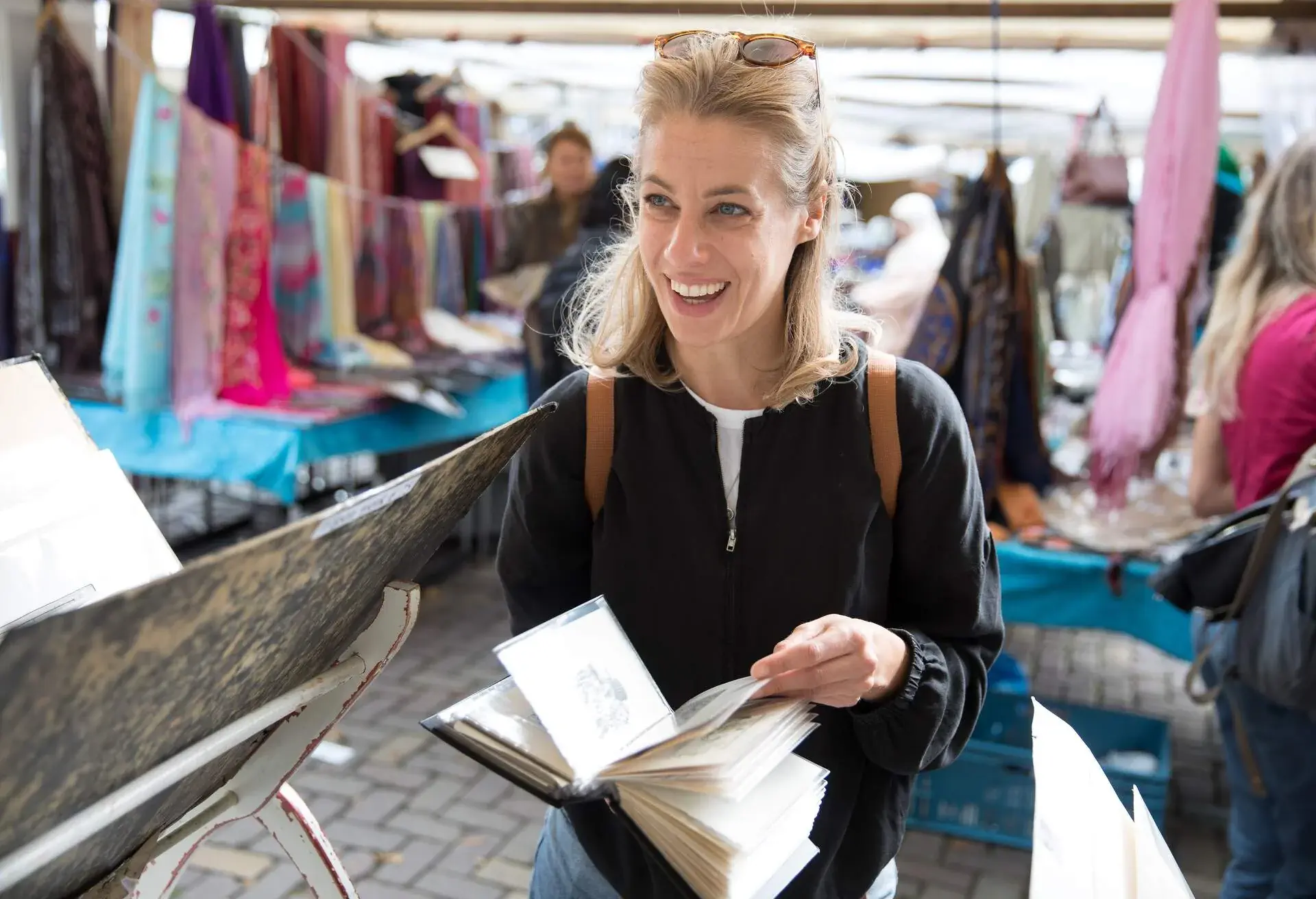 Girl looking at books in an antiques market.