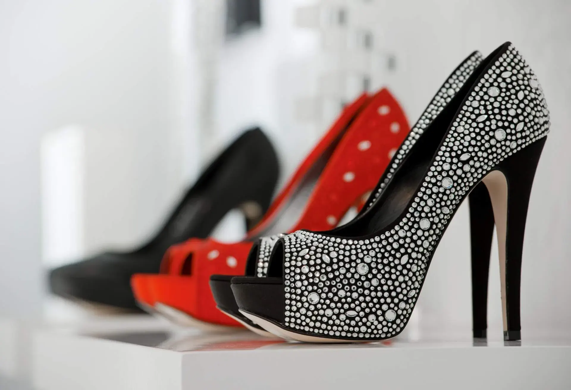 A vibrant display of colourful and bright women's stilettos in a shop.