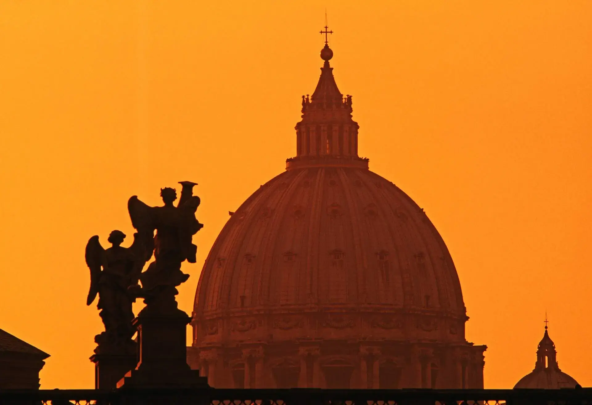 Dome of St. Peter's Basilica and Bernini's angels on Sant Angelo Bridge. Rome, Italy