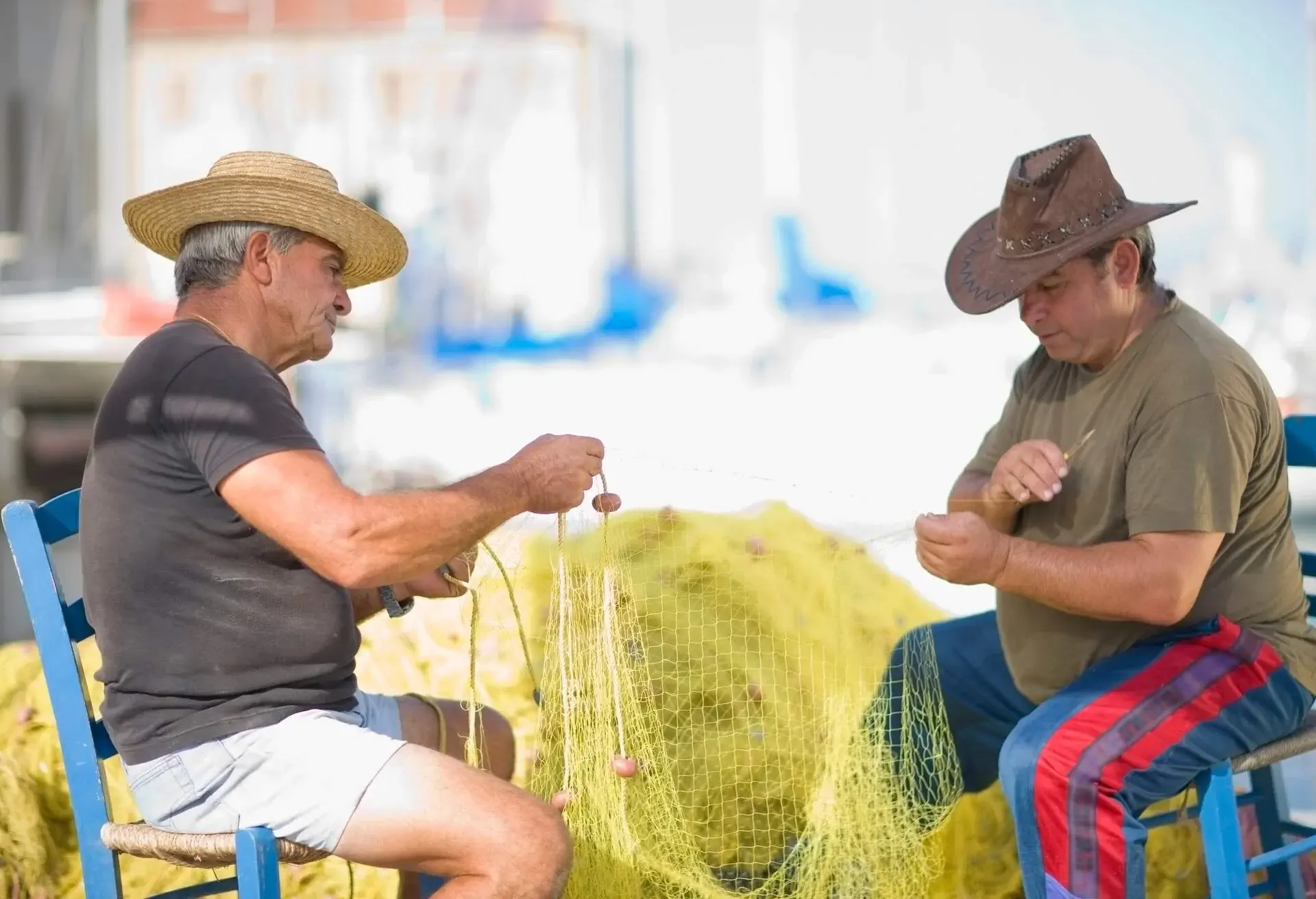 DEST_GREECE_CRETE_CHANIA_THEME_PEOPLE_LOCAL_FISHINGMEN_NET_GettyImages-110052902.jpg