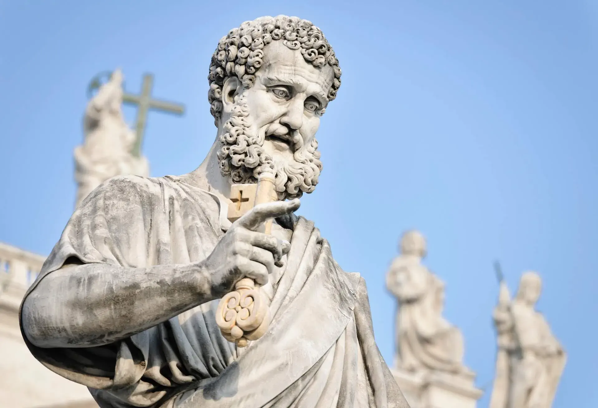 Close-up of a 19th Century statue by Giuseppe De Fabris, showing Saint Peter the Apostle holding a gold key (symbolising the key to heaven). The statue is located in St Peter's Square in the Vatican City, Rome.