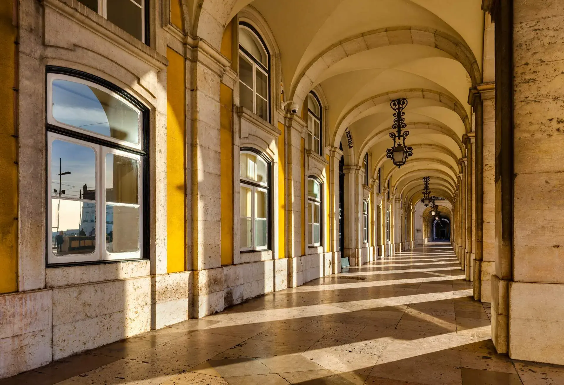 Gallery with arcades at Praca do Comercio - Lisbon, Portugal.