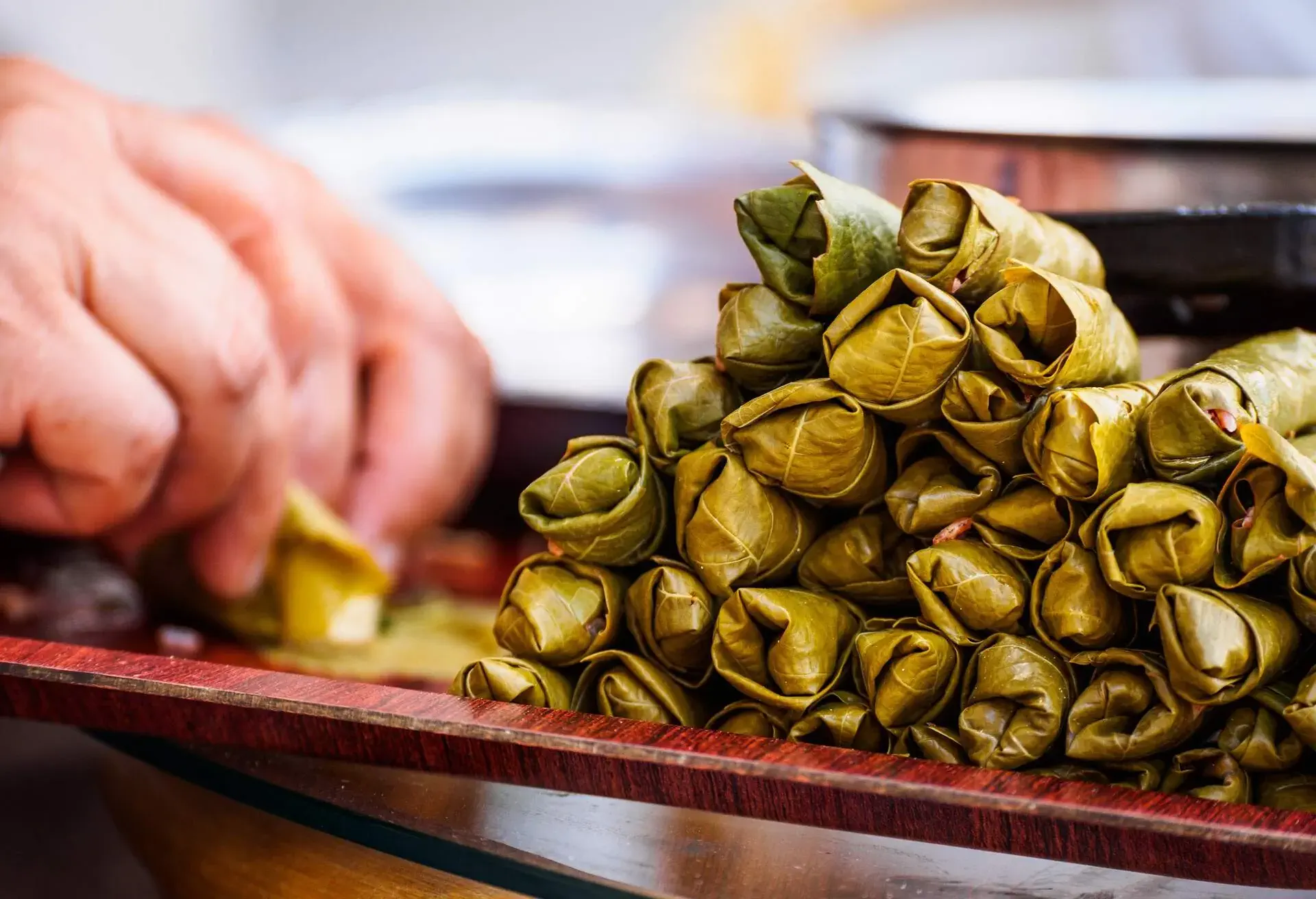 Woman making dolmades, the traditional vine-leaf rolls filled with a spicy rice mixture, in Göreme, Cappadocia, Turkey