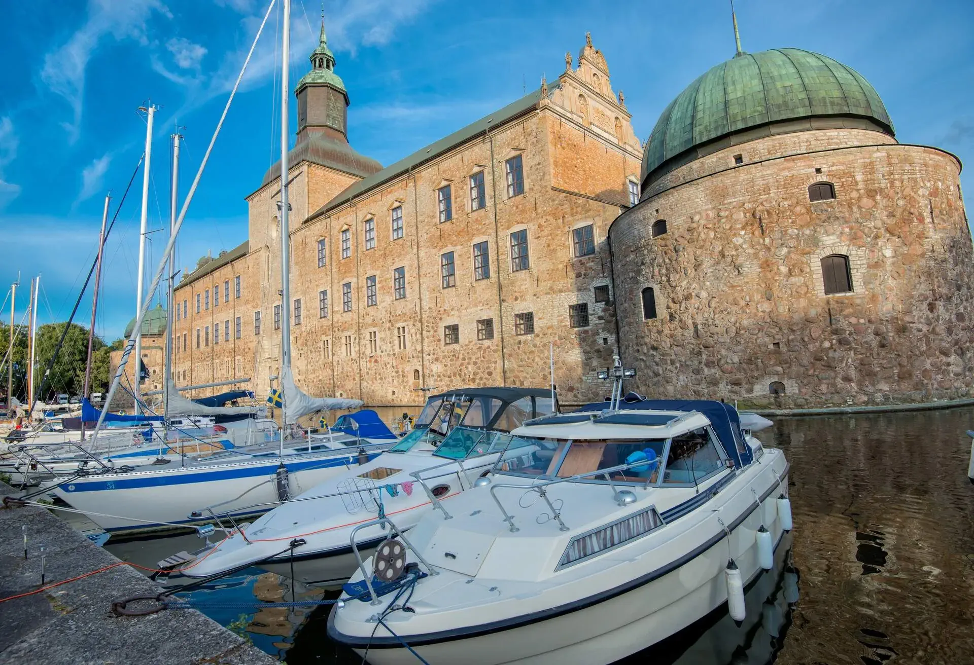 A summer evening at Vadstena Castle in Ostergotland, Sweden. The castle was built in 1545 as a Royal Castle by king Gustav I. Today Vadstena is a popular destination for leisure boats and tourists.
