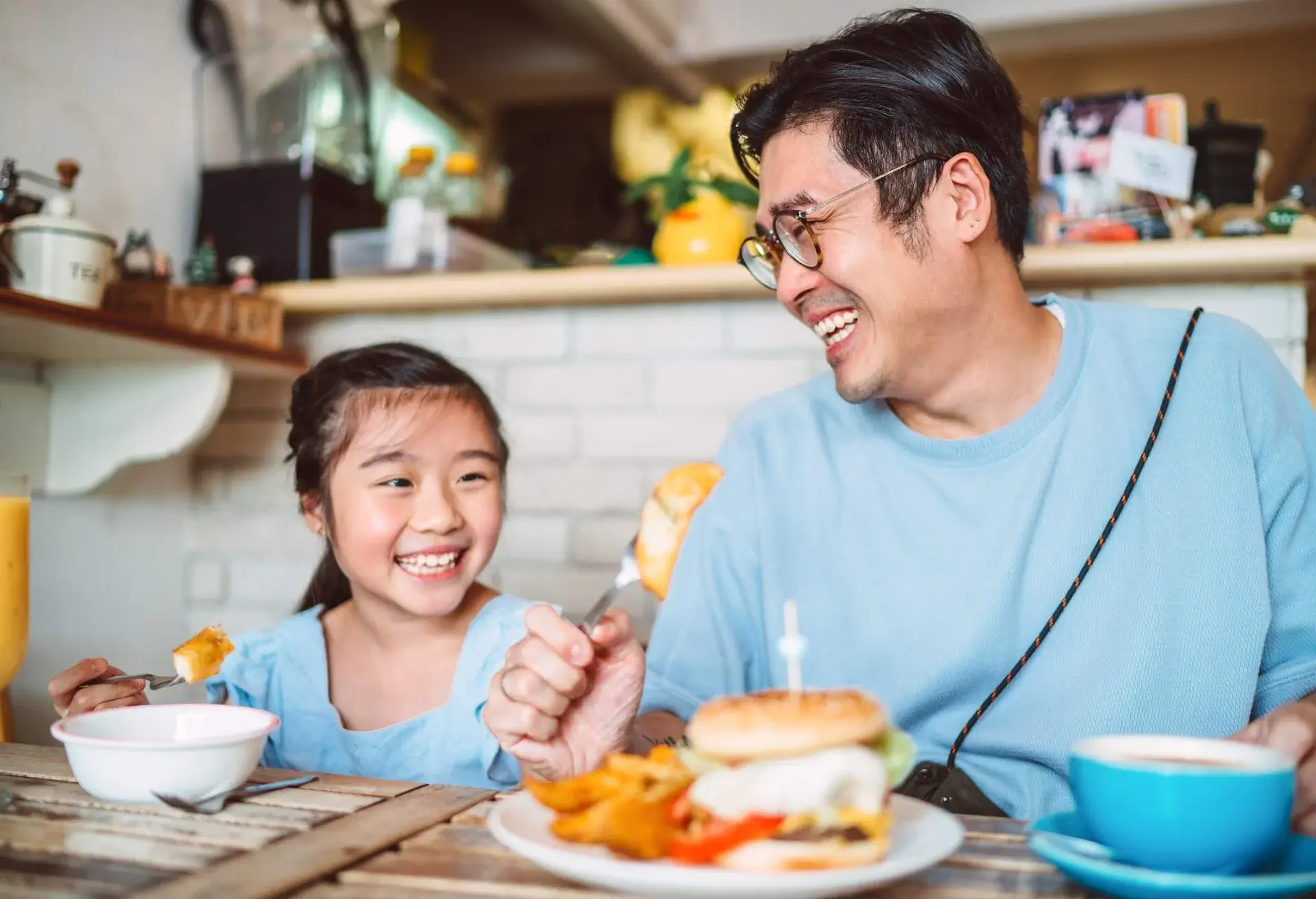 Young girl having meal in restaurant.
