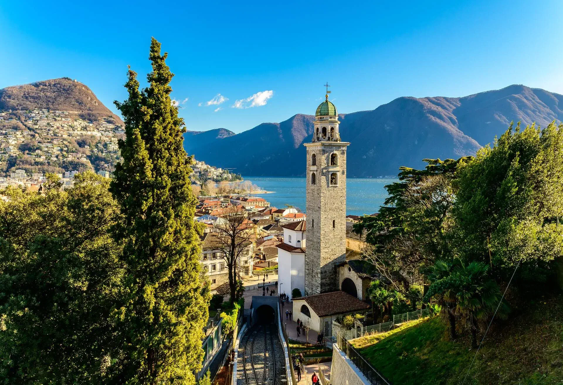 View over the city of Lugano in Switzerland on a sunny winter day. The style of a lot of buildings and churches in Lugano has italian influence due the proximity of the italian border.