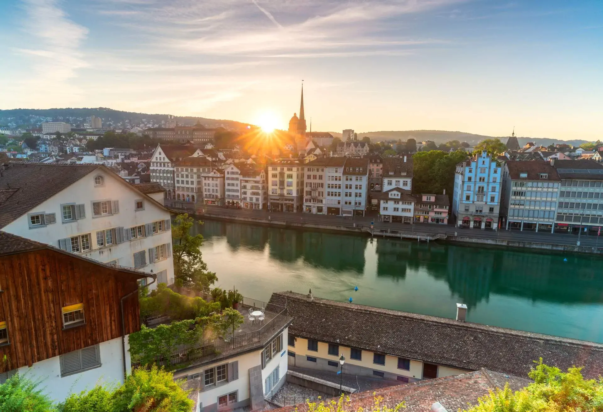 Sunburst at sunrise over Limmat River seen from Lindenhof Hill, Zurich, Switzerland
