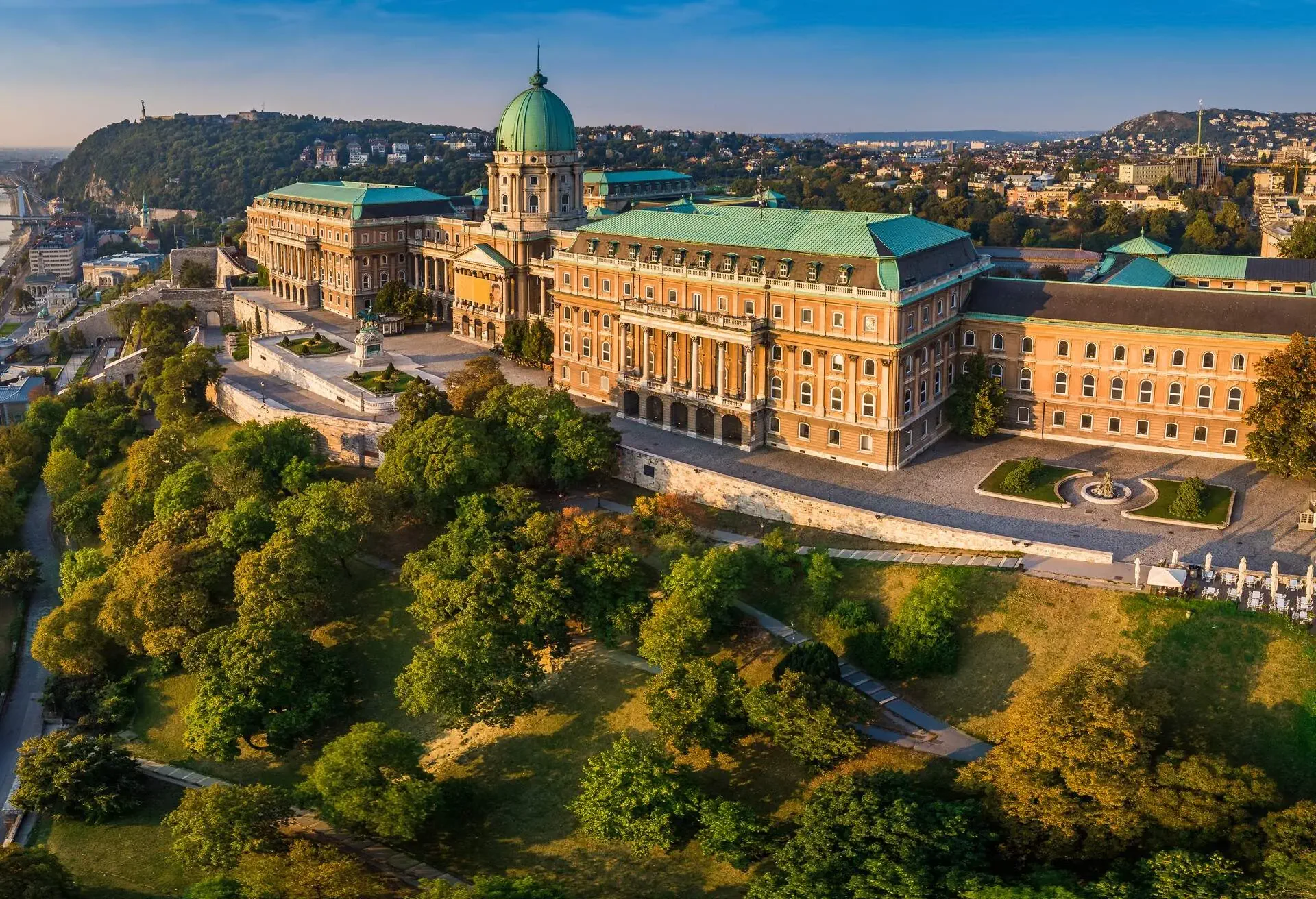 Budapest, Hungary - Aerial panoramic view of the beautiful Buda Castle Royal Palace at sunrise with Gellert Hill and Statue of Liberty at background