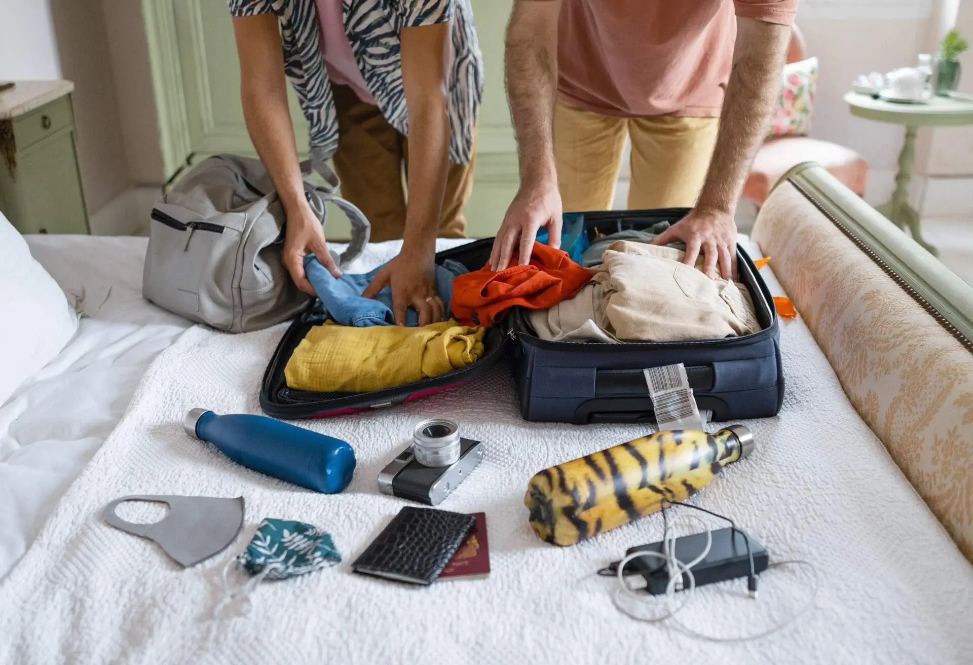 A couple packing their luggage before traveling
