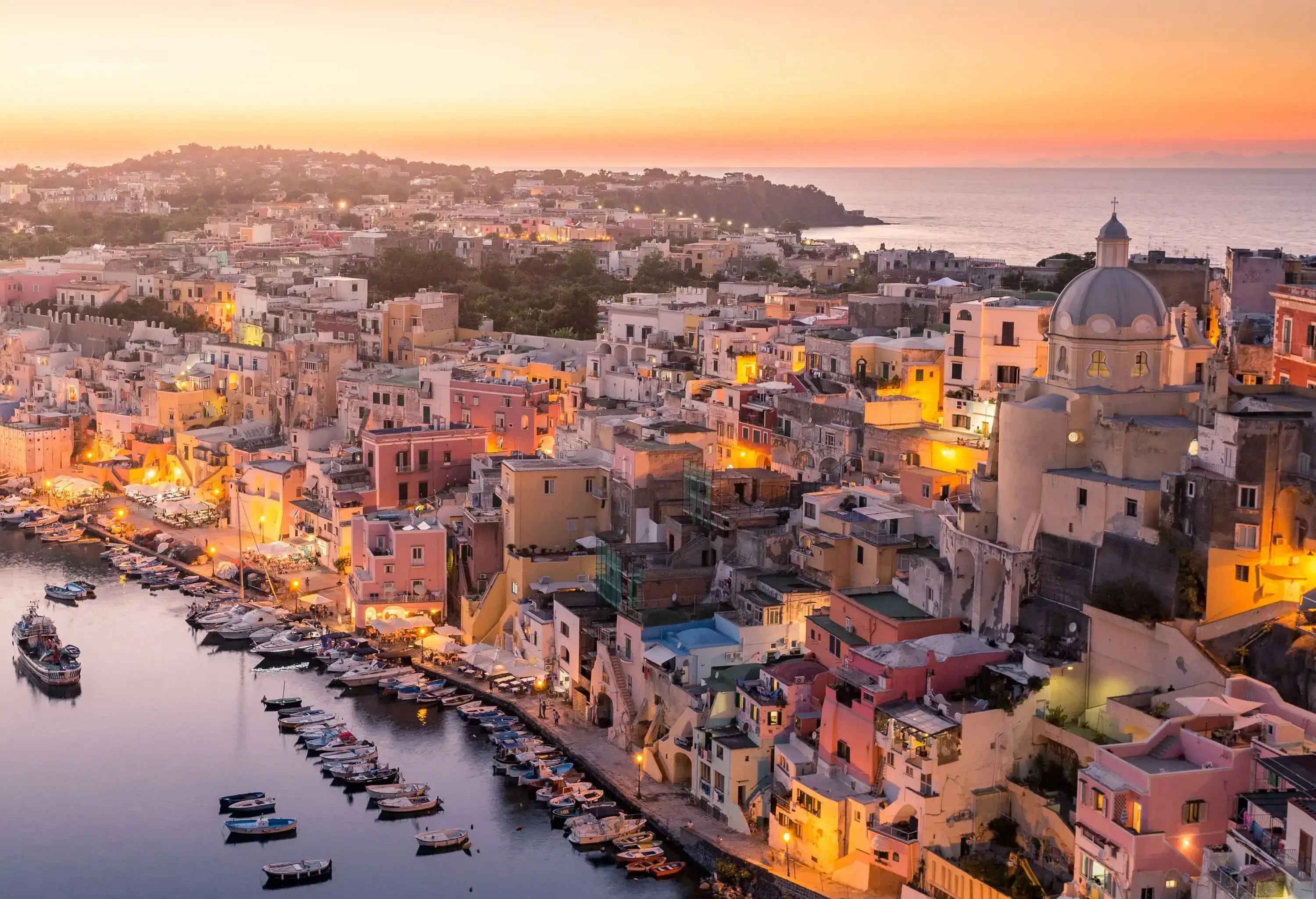Procida, Naples, colorful island in the italian sea coast. Sunset over La Corricella Harbour