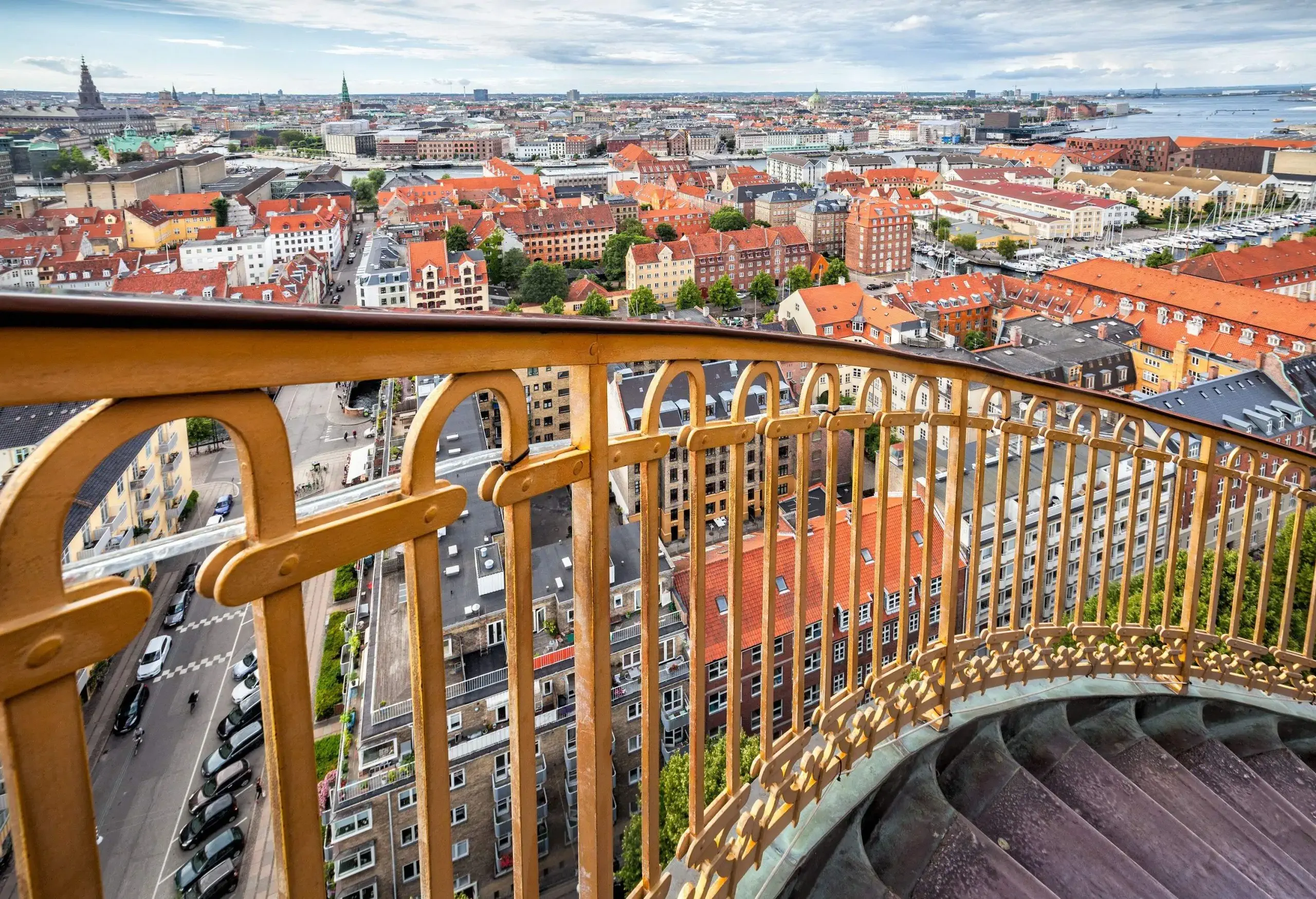 A staircase with railings overlooking a cityscape.