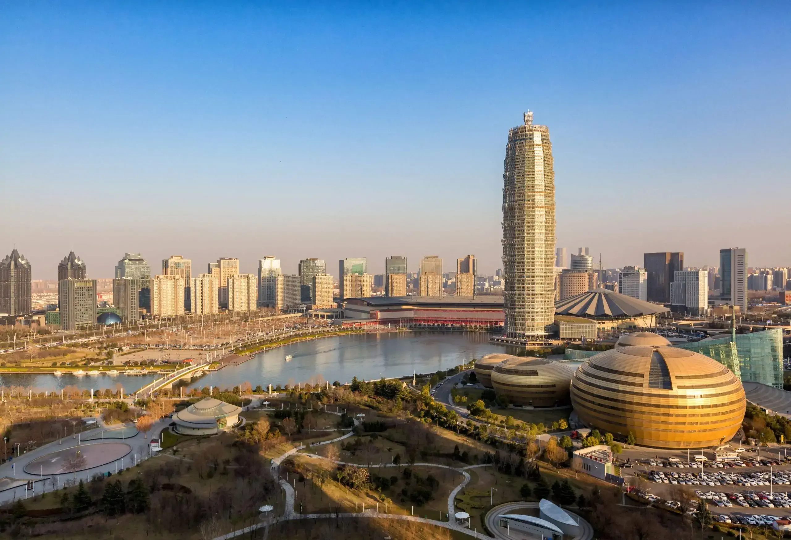 Tall and unique skyscrapers in a metropolitan area surrounding a river.