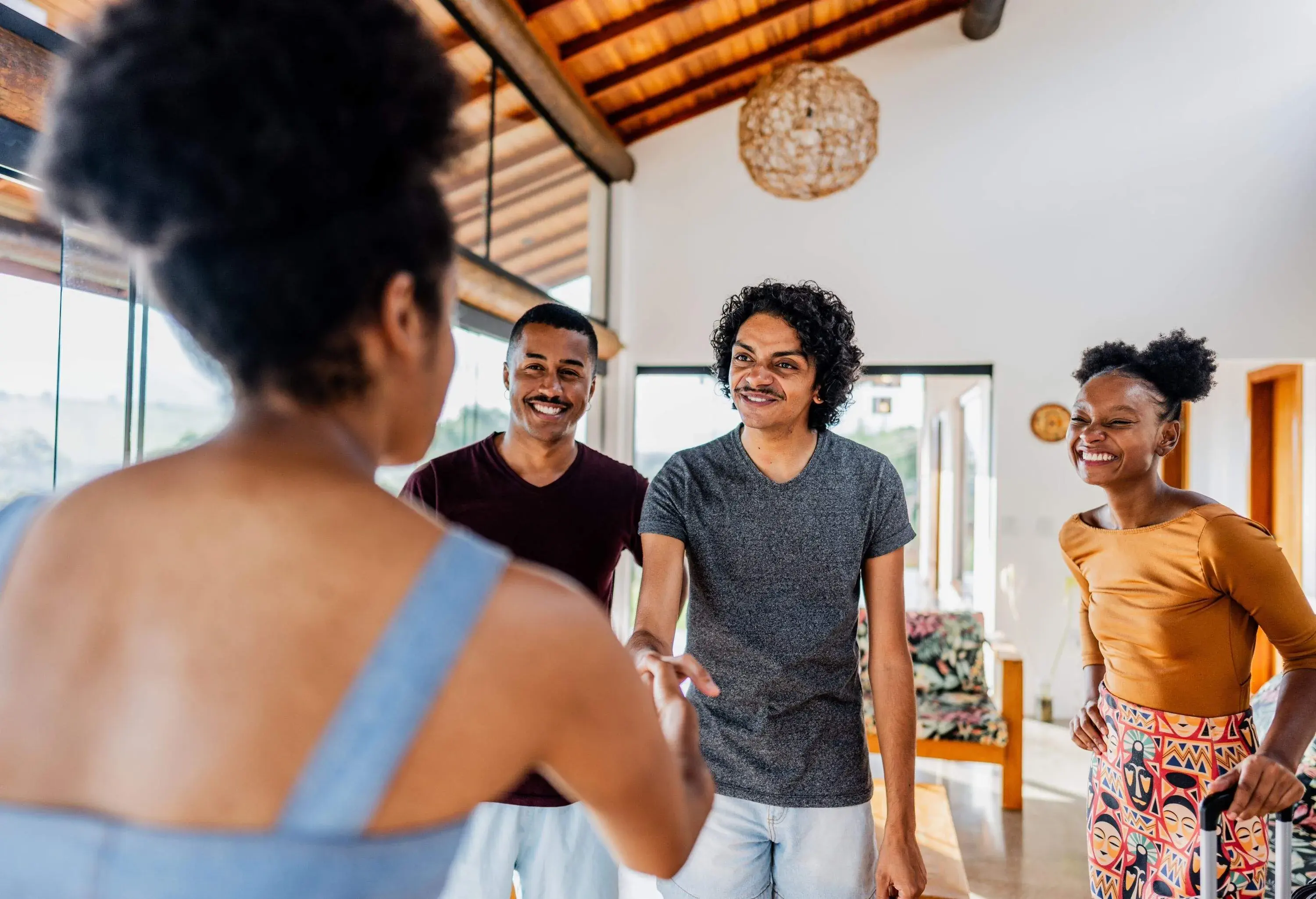 Vacation house owner greeting travelers and showing house renting