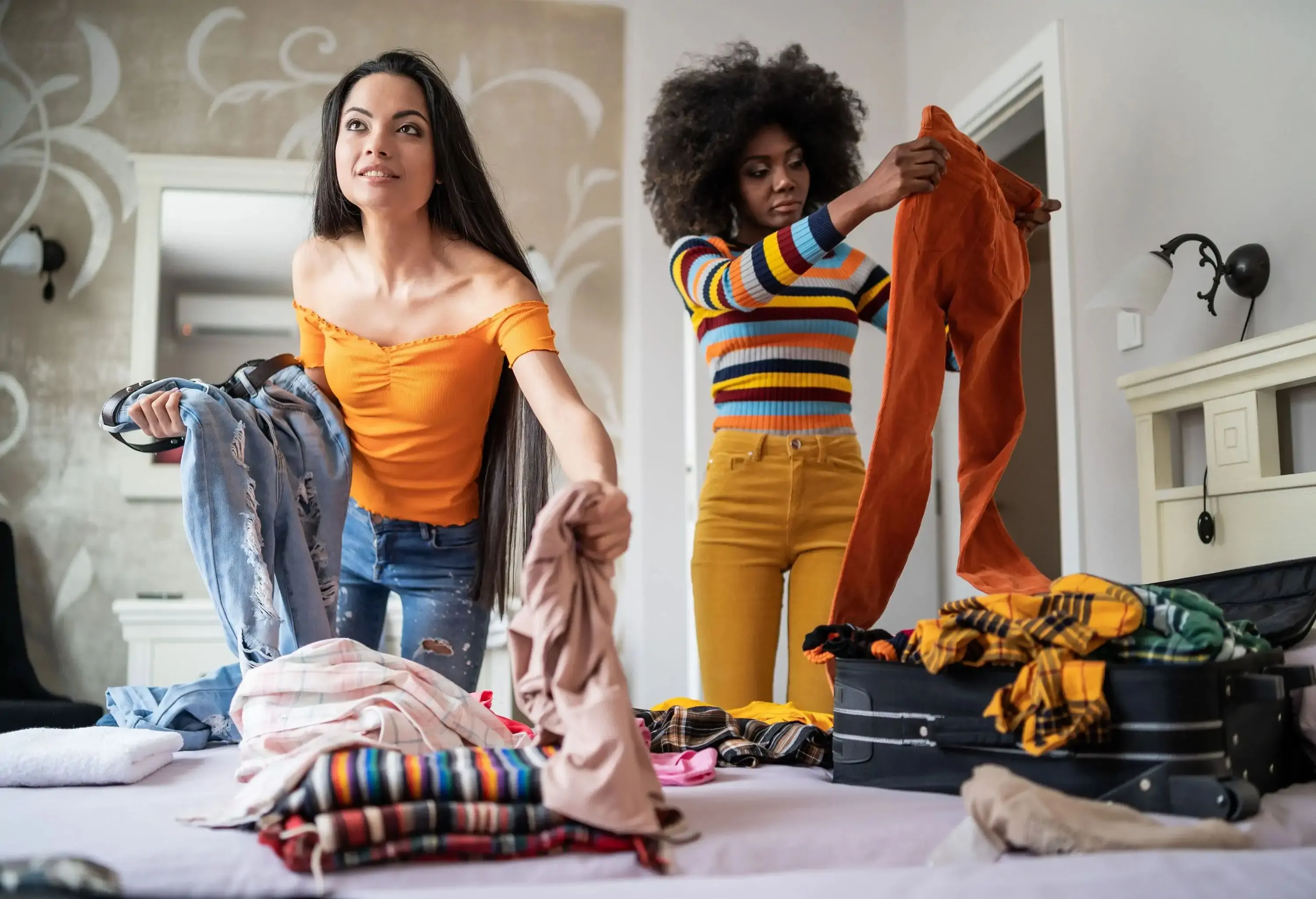 Girls packing clothes in suitcase for travel